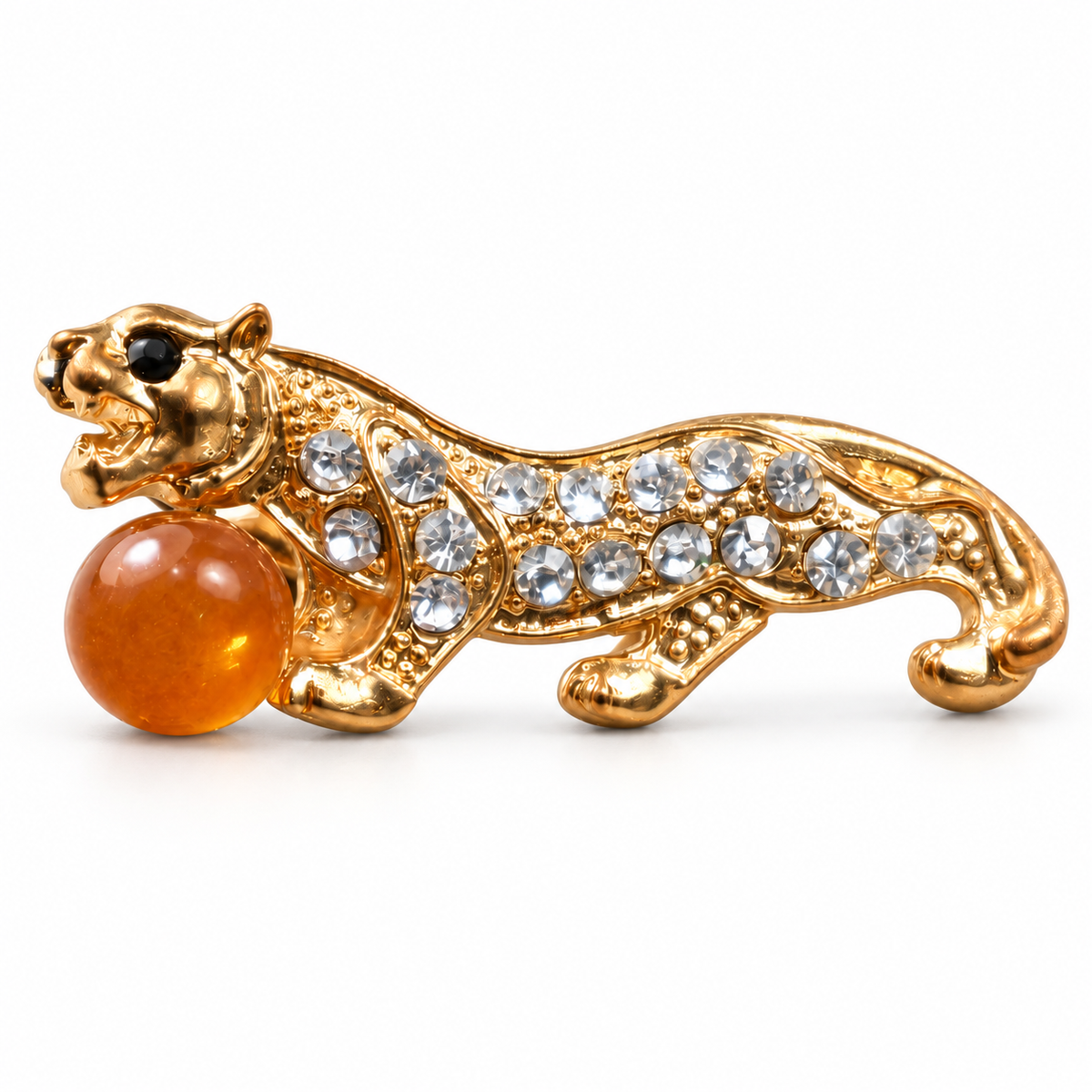 KIZIMA gold-tone tiger brooch 20N0120-19 with honey-orange Baltic amber on a white studio background.