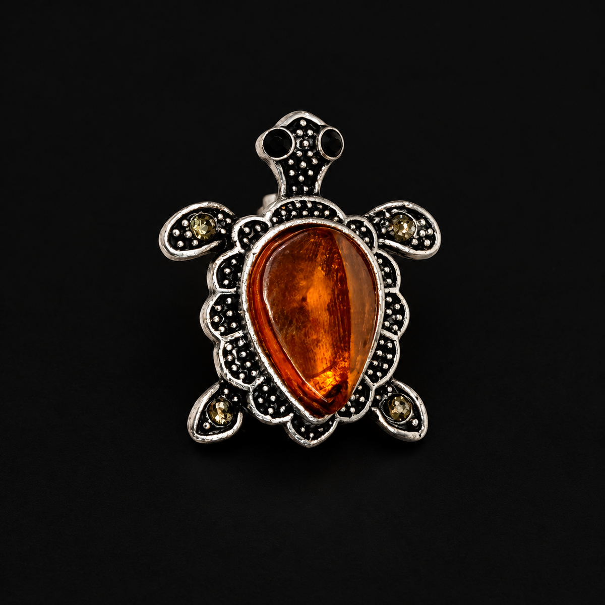 KIZIMA Baltic amber brooch 20N0180-8 on black studio background.