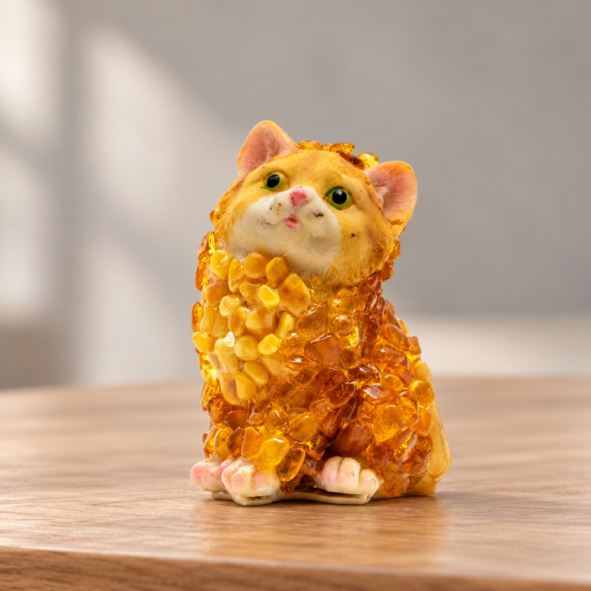 Baltic amber sitting cat figurine on a shelf in a softly lit home interior — handmade in Brooklyn by KIZIMA®