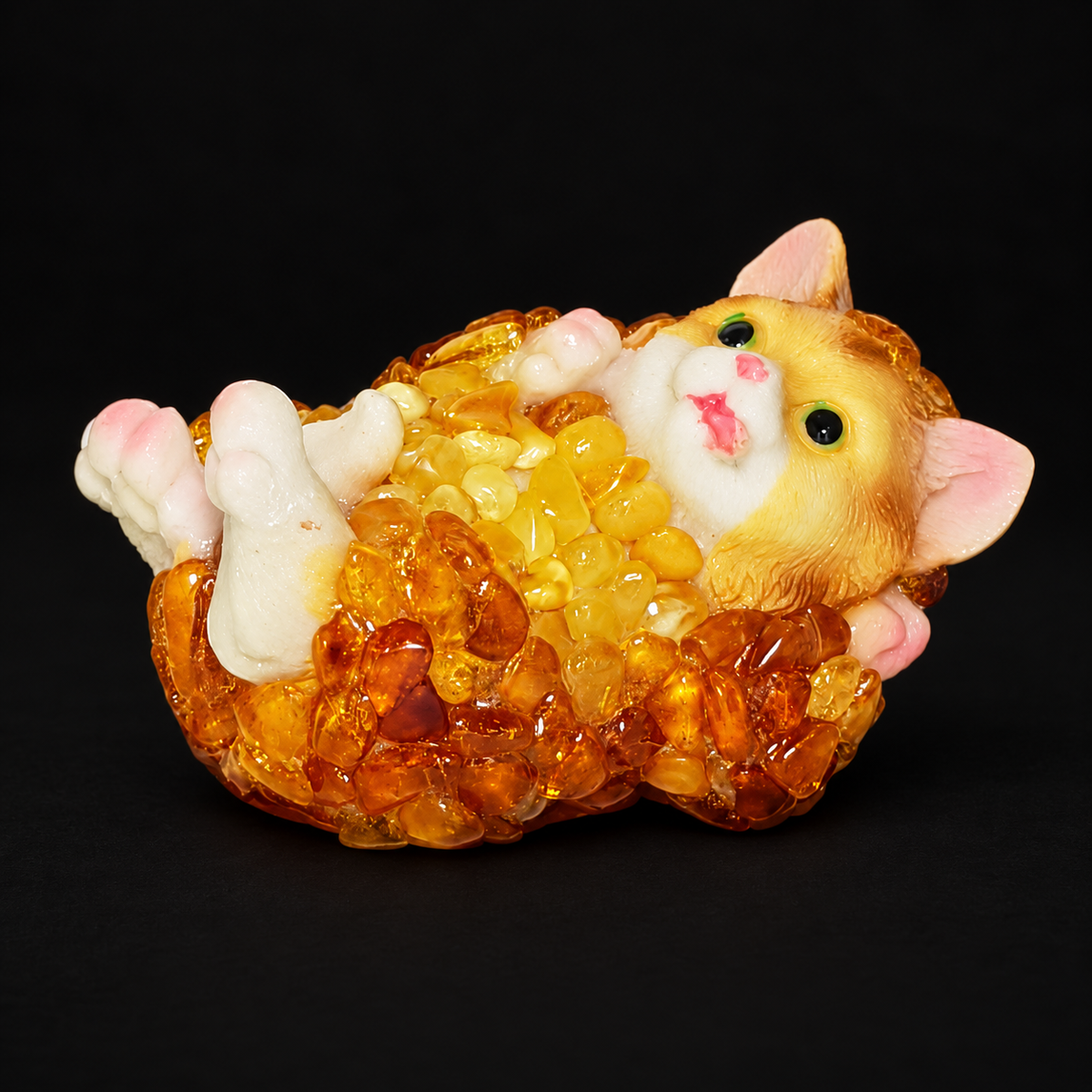 Made in USA Natural Baltic Amber cat figurine lying on its back with raised paws, amber mosaic kitten, black studio background — KIZIMA®