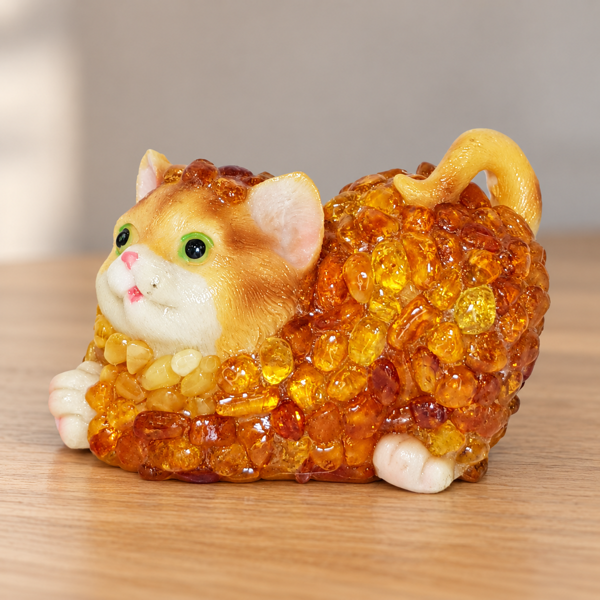 Baltic amber lying cat figurine on a shelf in a softly lit home interior — handmade in Brooklyn by KIZIMA®