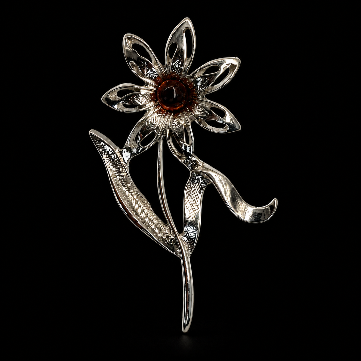 KIZIMA silver-tone seven-petal daisy with dark cognac amber center brooch on black studio background.