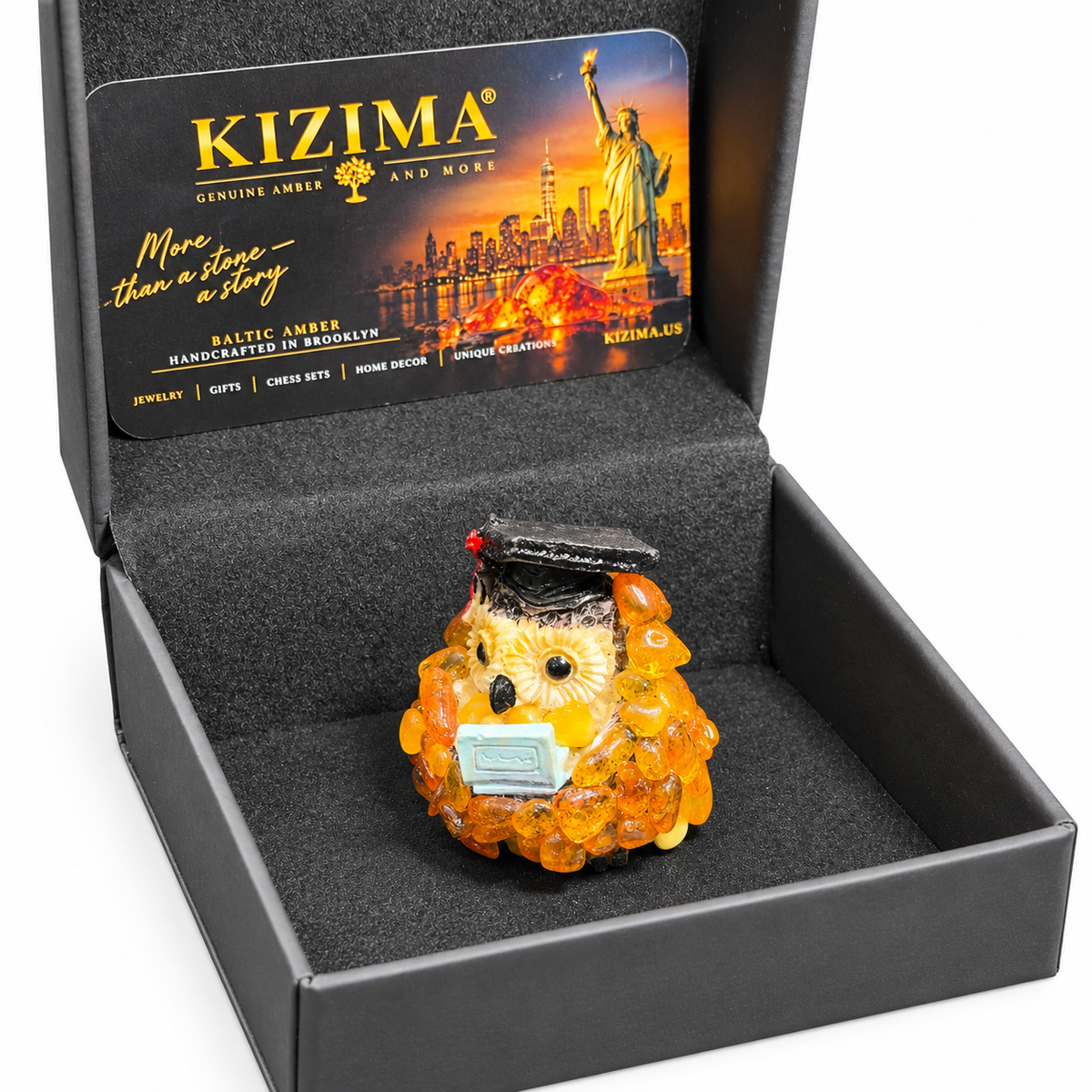 Graduation owl figurine displayed inside its open dark KIZIMA presentation box