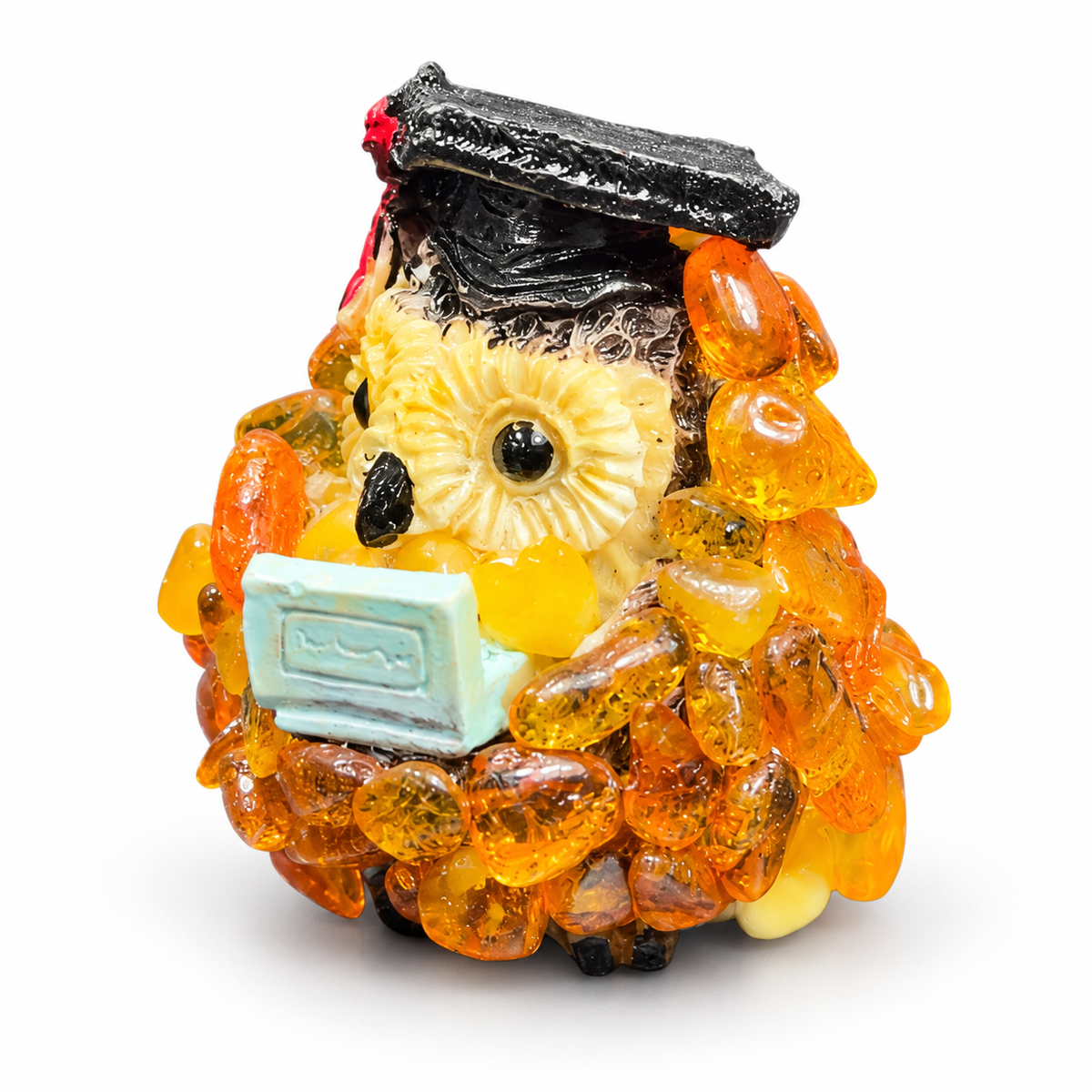 Cream-faced graduation owl with orange chips and a red tassel on a white background