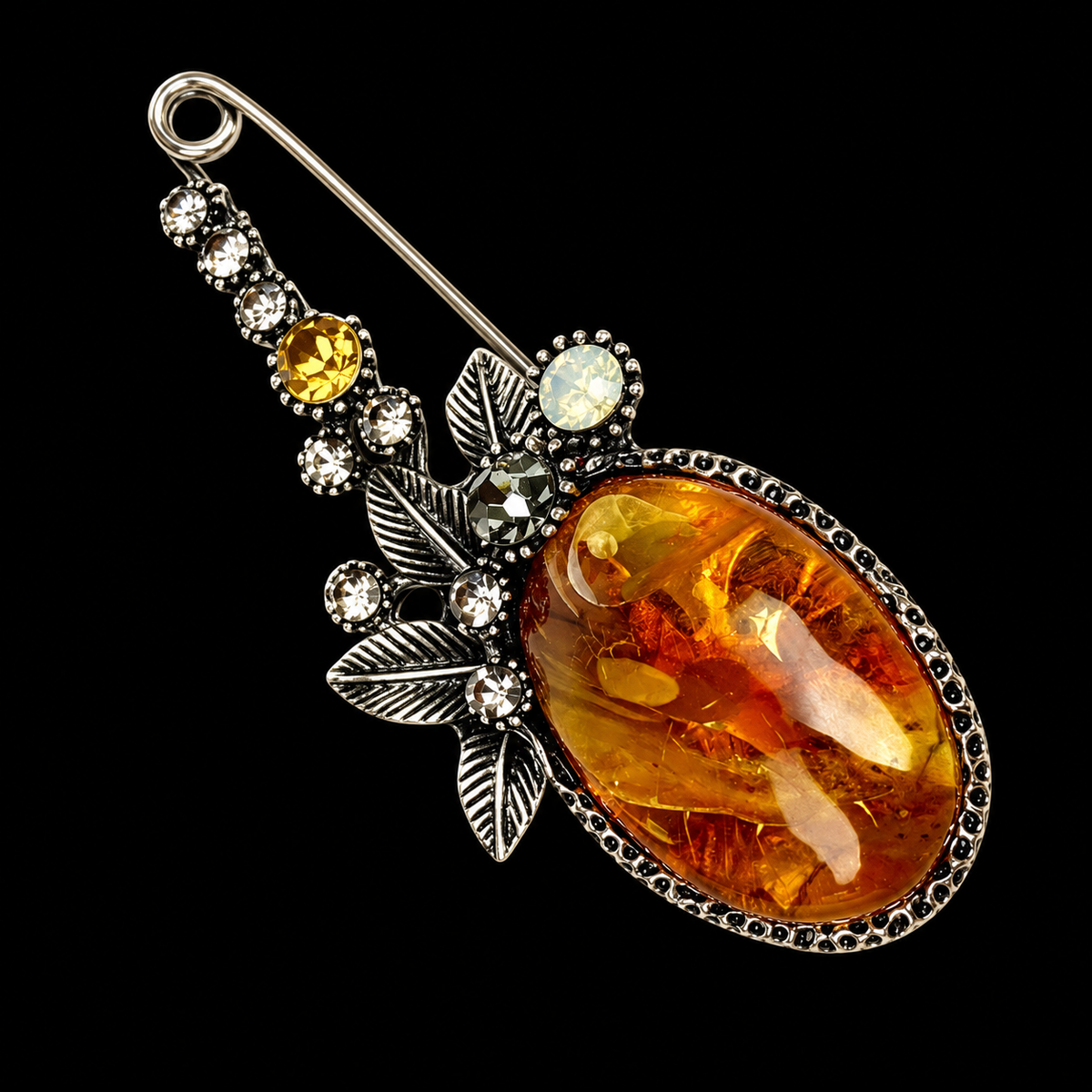 KIZIMA landscape amber safety-pin brooch 20N0900-2 on black studio background.