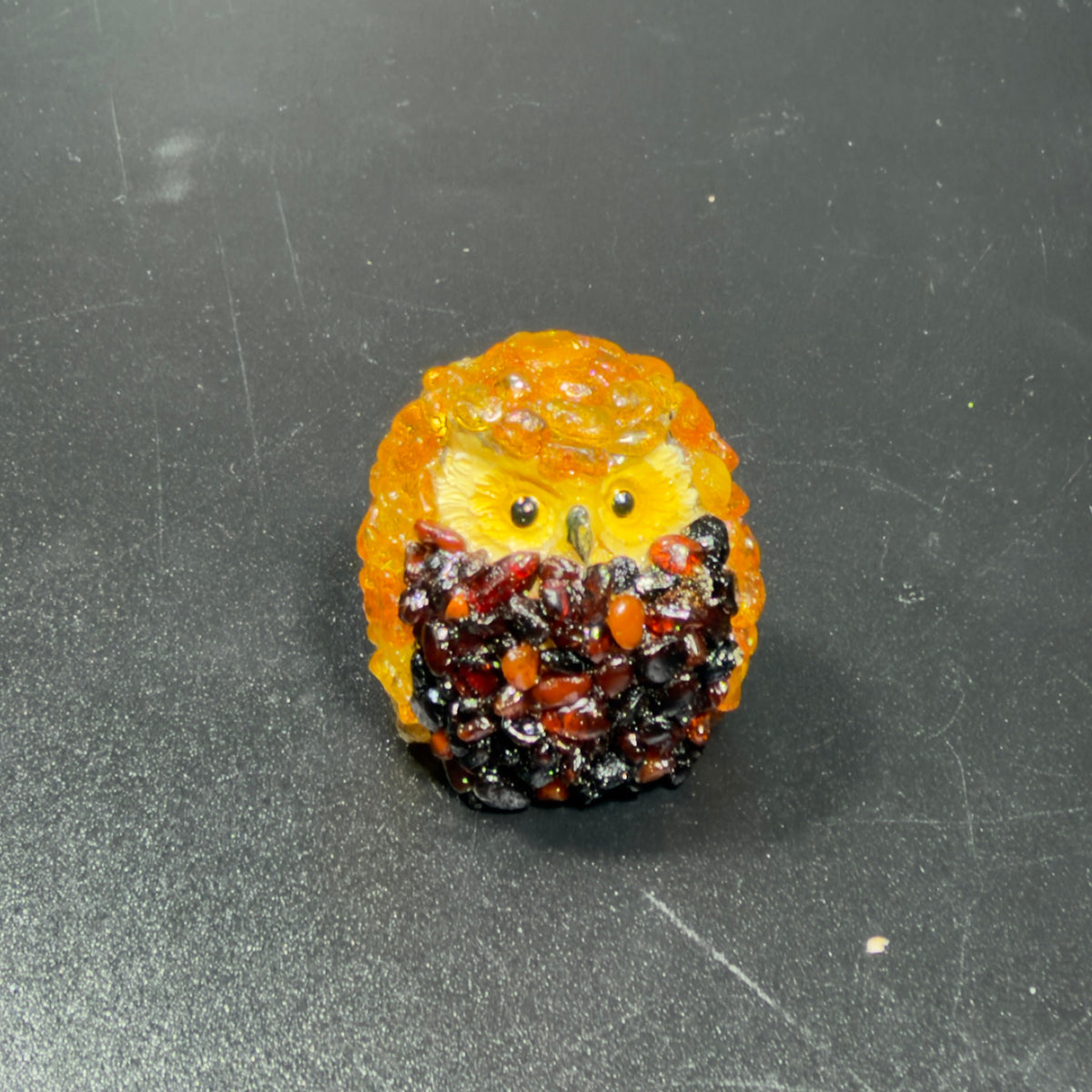 Original front photo of the golden-orange owl figurine with yellow face and dark reddish-brown textured front