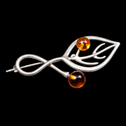 KIZIMA silver-tone openwork leaf and two amber beads brooch 20G0150q3, black studio background.