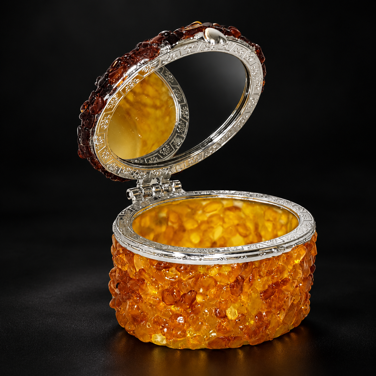 KIZIMA oval Baltic amber jewelry box 5598567 open with engraved silver-tone rim and mirror against a premium black studio background