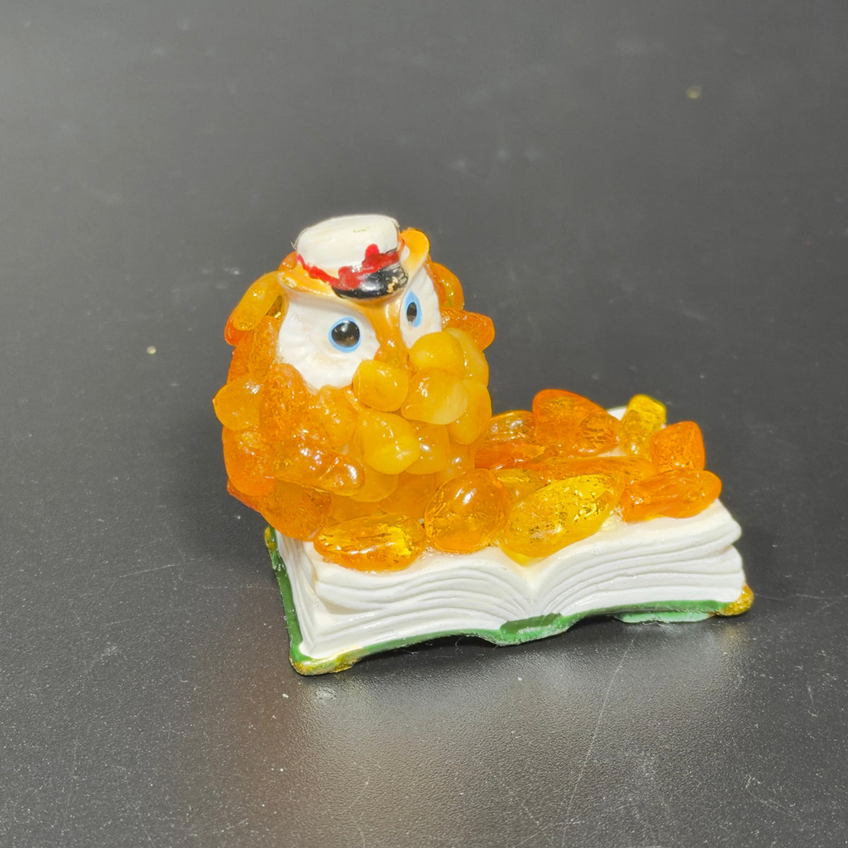 Original photograph of the orange amber owl-on-book figurine.