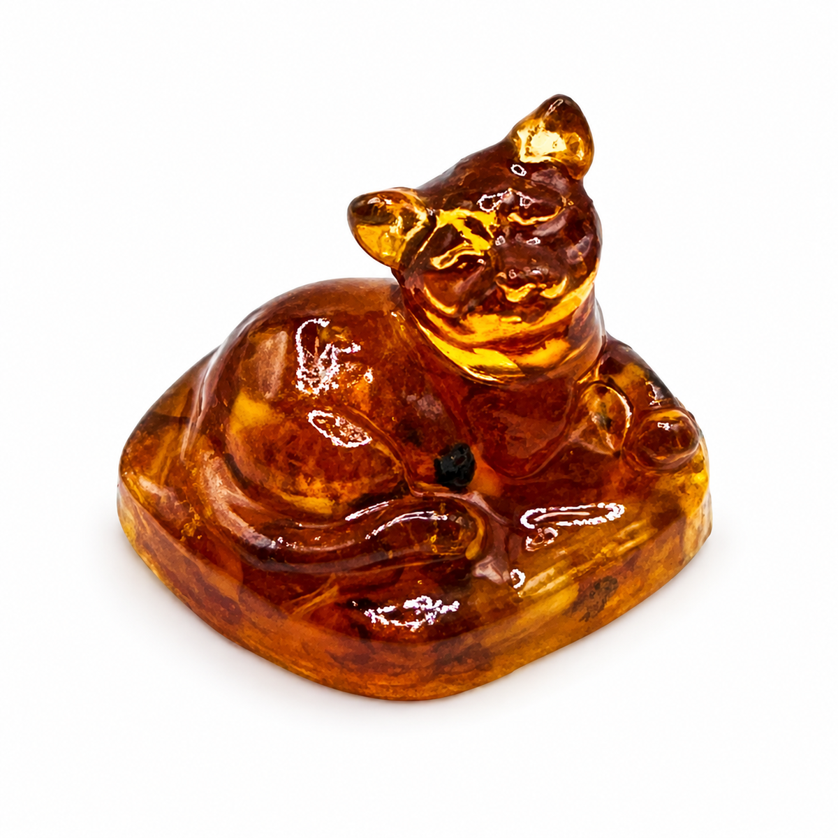 Reclining cat figurine on its rounded rectangular base, photographed on white.
