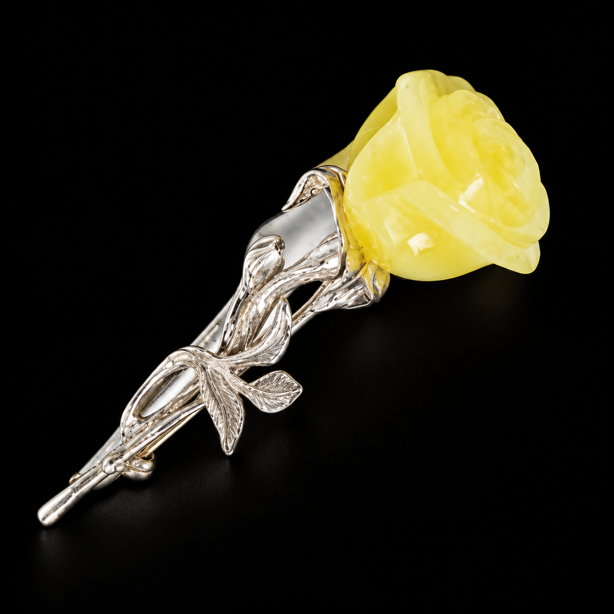 KIZIMA opaque pale yellow amber rose brooch on black studio background.