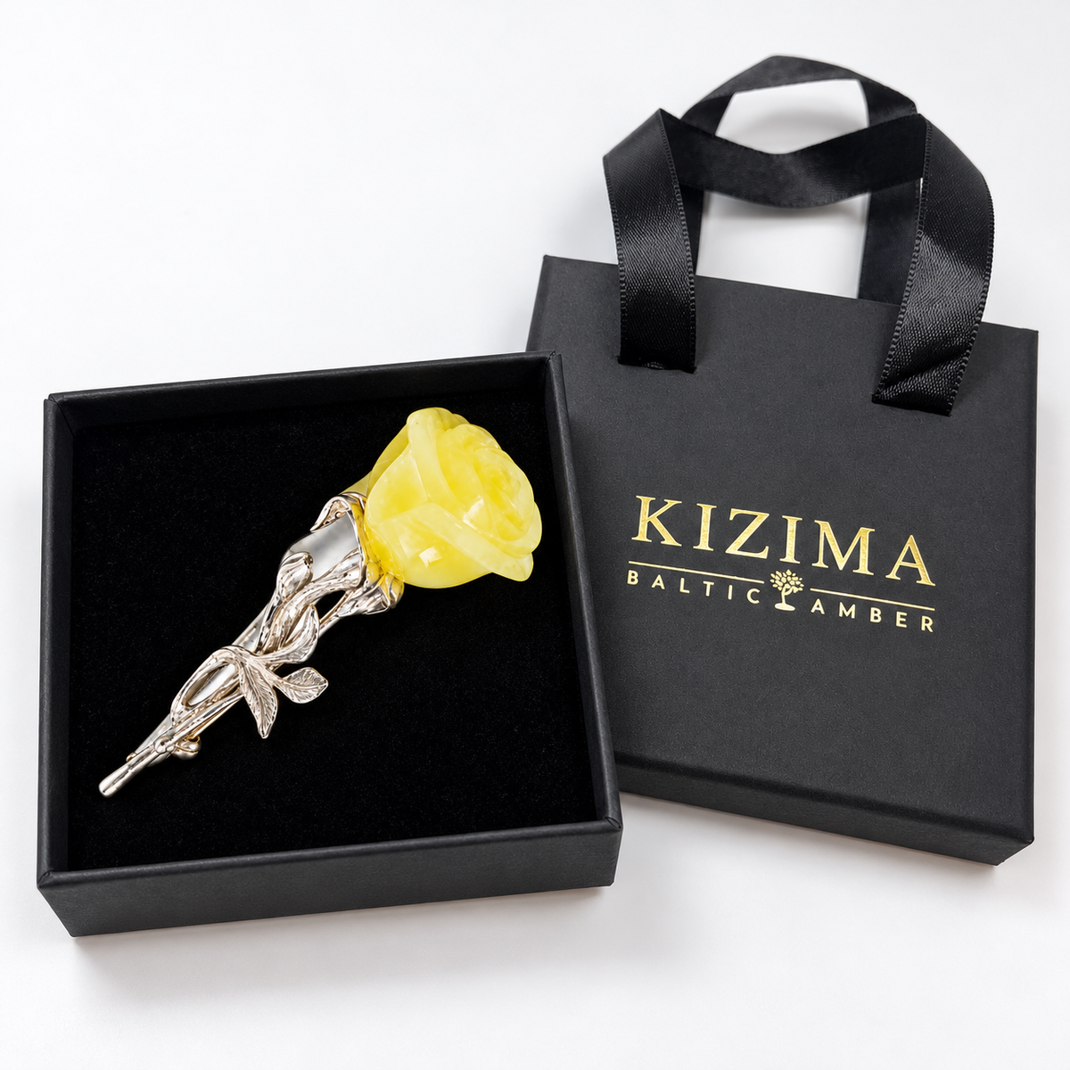 KIZIMA opaque pale yellow amber rose brooch in actual black KIZIMA gift packaging.