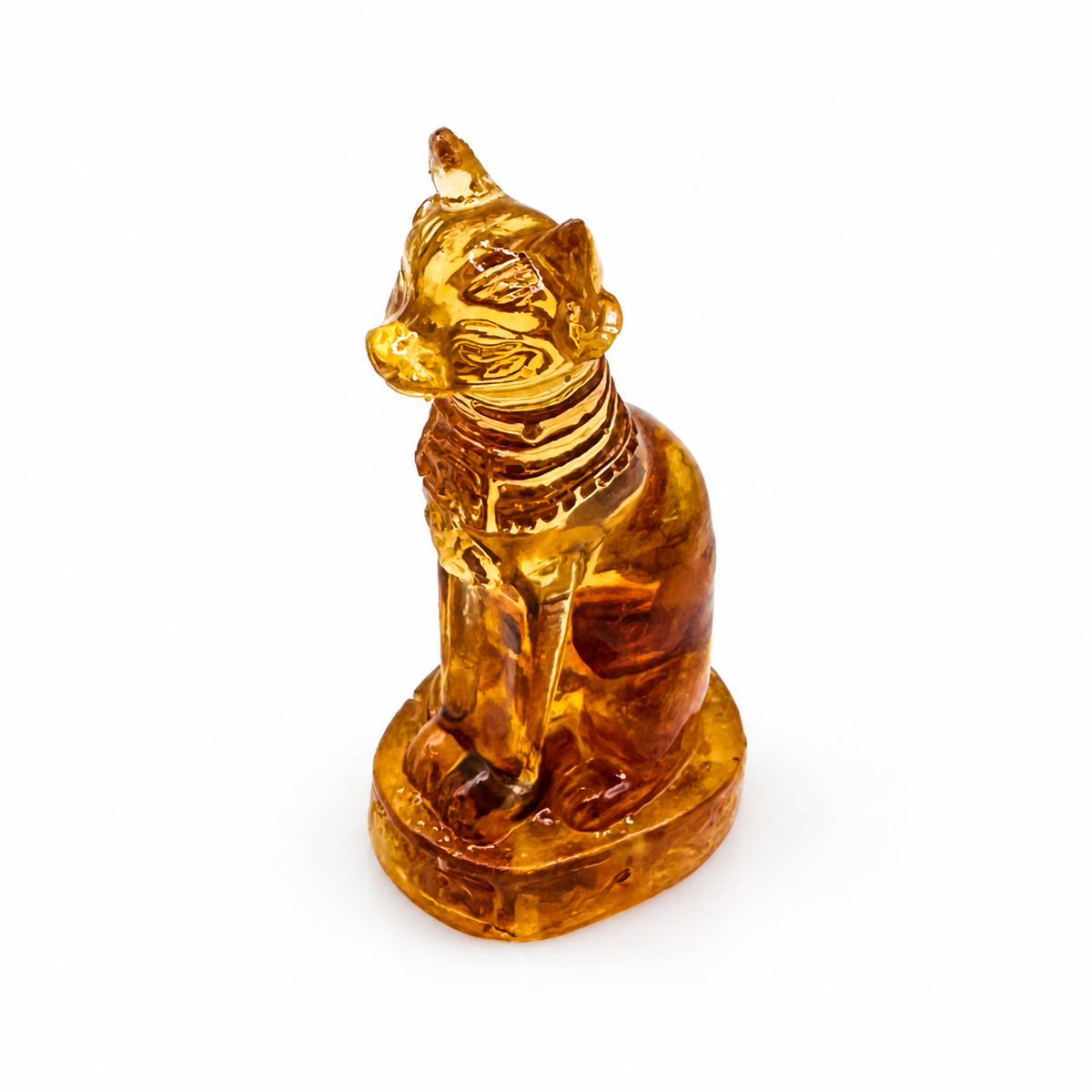 Sphinx cat sculpture with long front legs and an oval base, photographed on white.