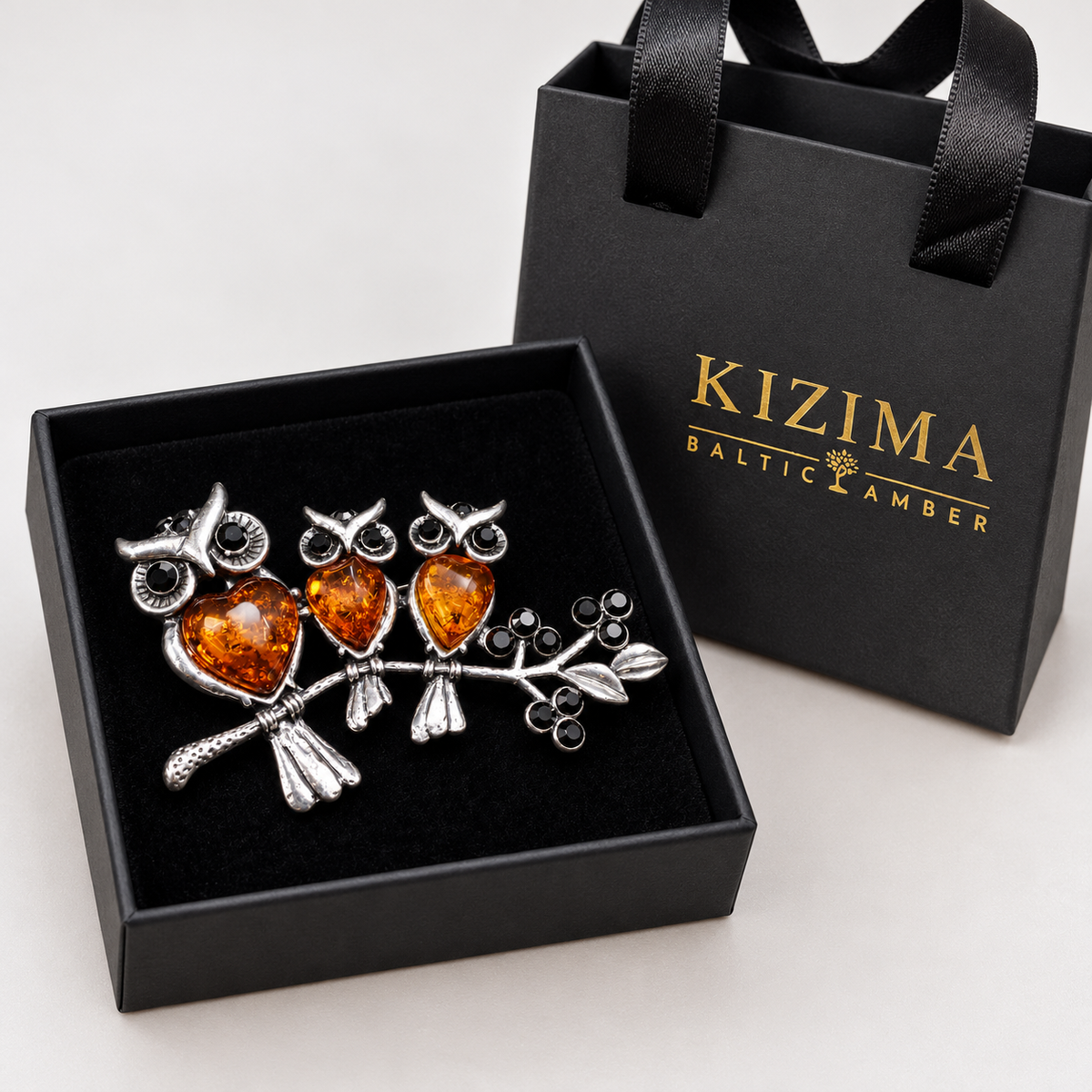 KIZIMA three cognac amber owls brooch 20-203Q19-6-4-1, with actual KIZIMA gift packaging.
