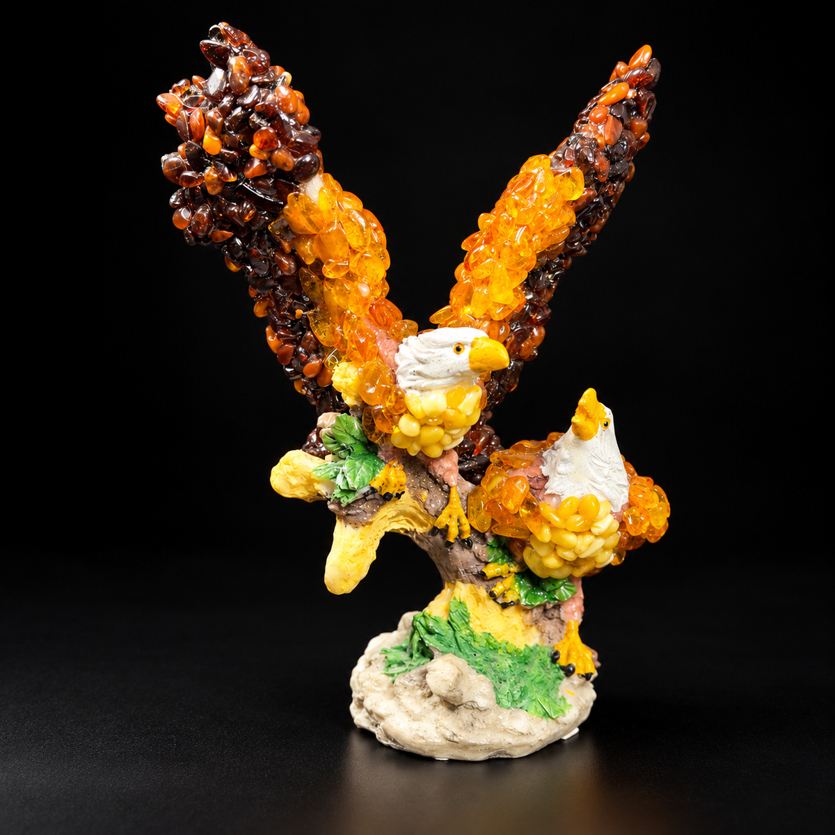 KIZIMA two bald eagles Baltic amber figurine on a leafy branch against a black studio background, SKU 18-02Q200-3-5-6.