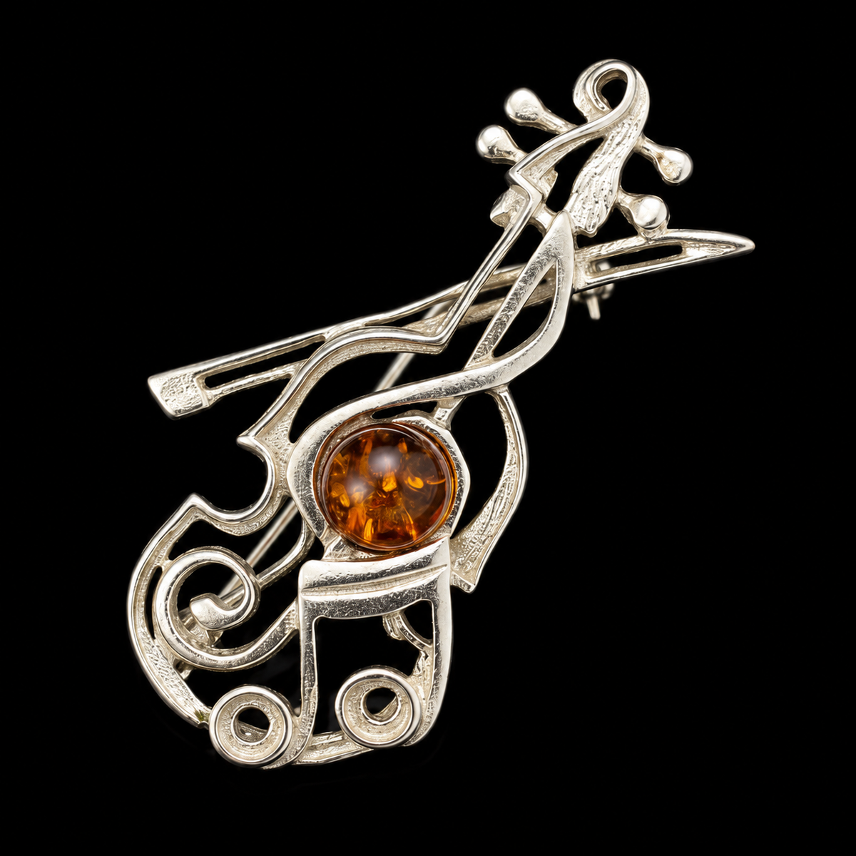 KIZIMA silver-tone violin and bow brooch with cognac Baltic amber on black studio background.