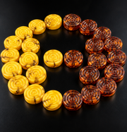 Made in USA Natural Baltic Amber backgammon pieces, butterscotch and cognac amber checkers on a black studio background by KIZIMA®