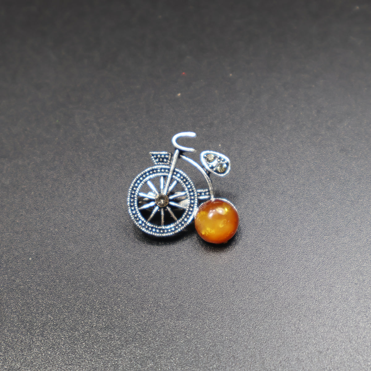 Made in USA Genuine Natural Baltic Amber Bicycle Brooch by KIZIMA® — handmade amber jewelry, angled view