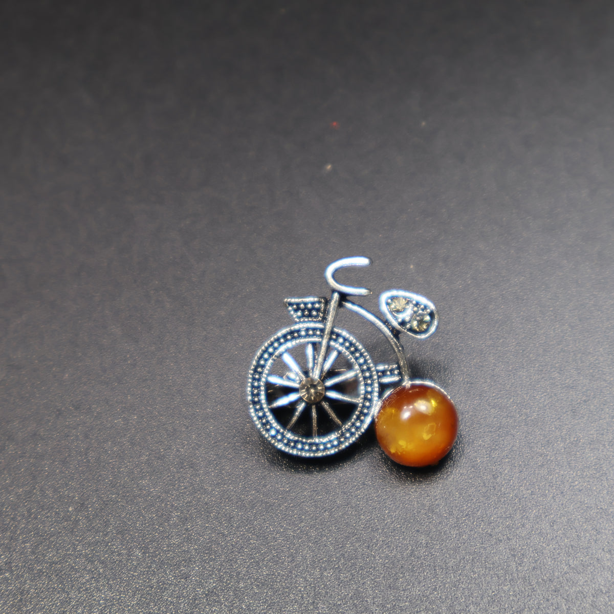 Made in USA Genuine Natural Baltic Amber Bicycle Brooch by KIZIMA® — handmade amber jewelry, close-up