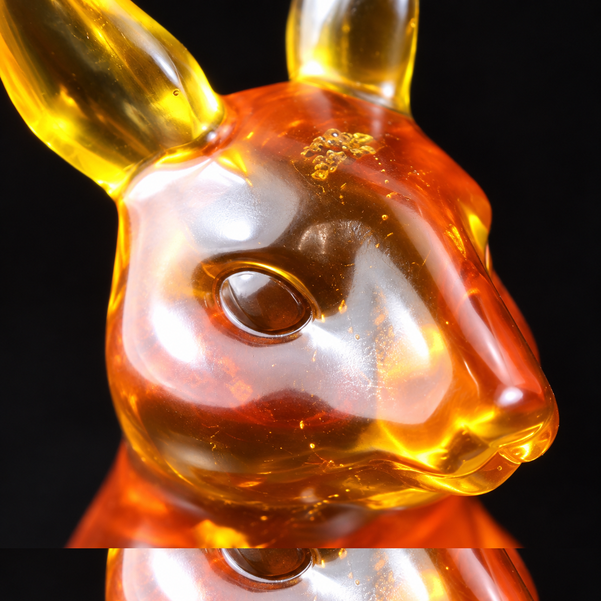 Macro detail of the amber kangaroo's face and ears in honey and cognac Baltic amber, Made in USA by KIZIMA®