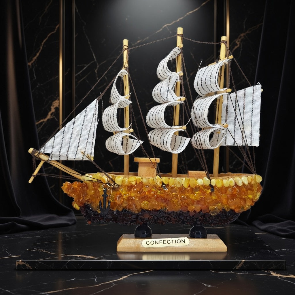 Made in USA natural Baltic amber and wood ship model by KIZIMA® — three-masted sailing ship with white fabric sails and an amber-encrusted hull