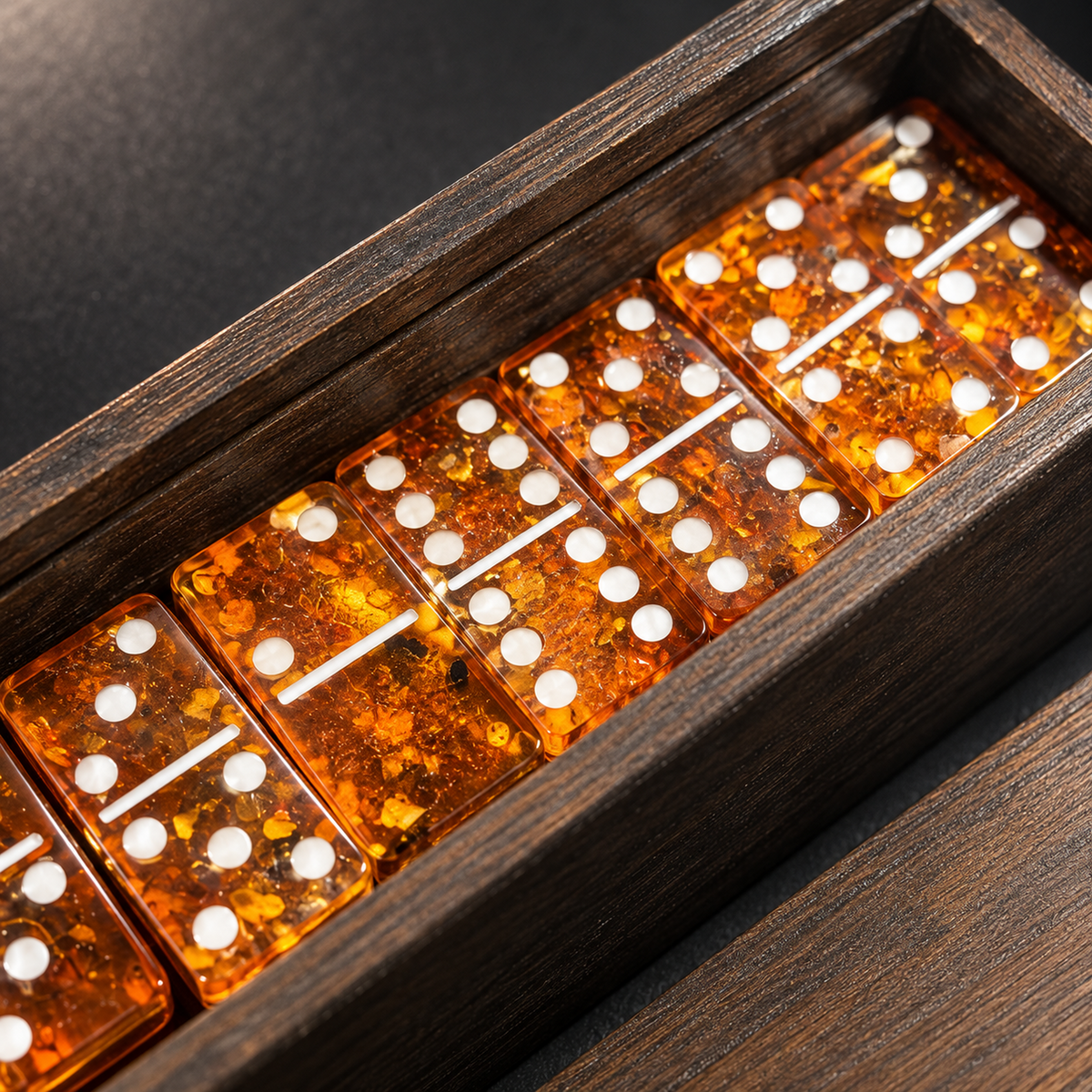 Macro detail of cherry Baltic amber domino tiles with white pips — natural golden inclusions in every handcrafted tile, KIZIMA® Brooklyn USA