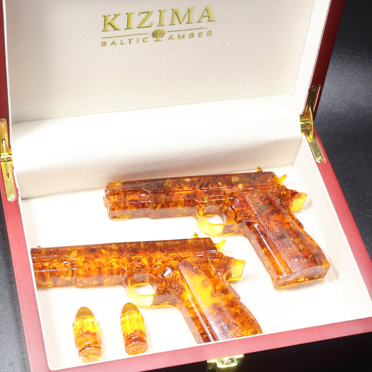 Handmade Baltic amber gun figurine close-up showing natural stone