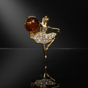 Made in USA genuine natural Baltic amber ballerina brooch by KIZIMA on glossy black studio background with reflection, luxury jewelry photography