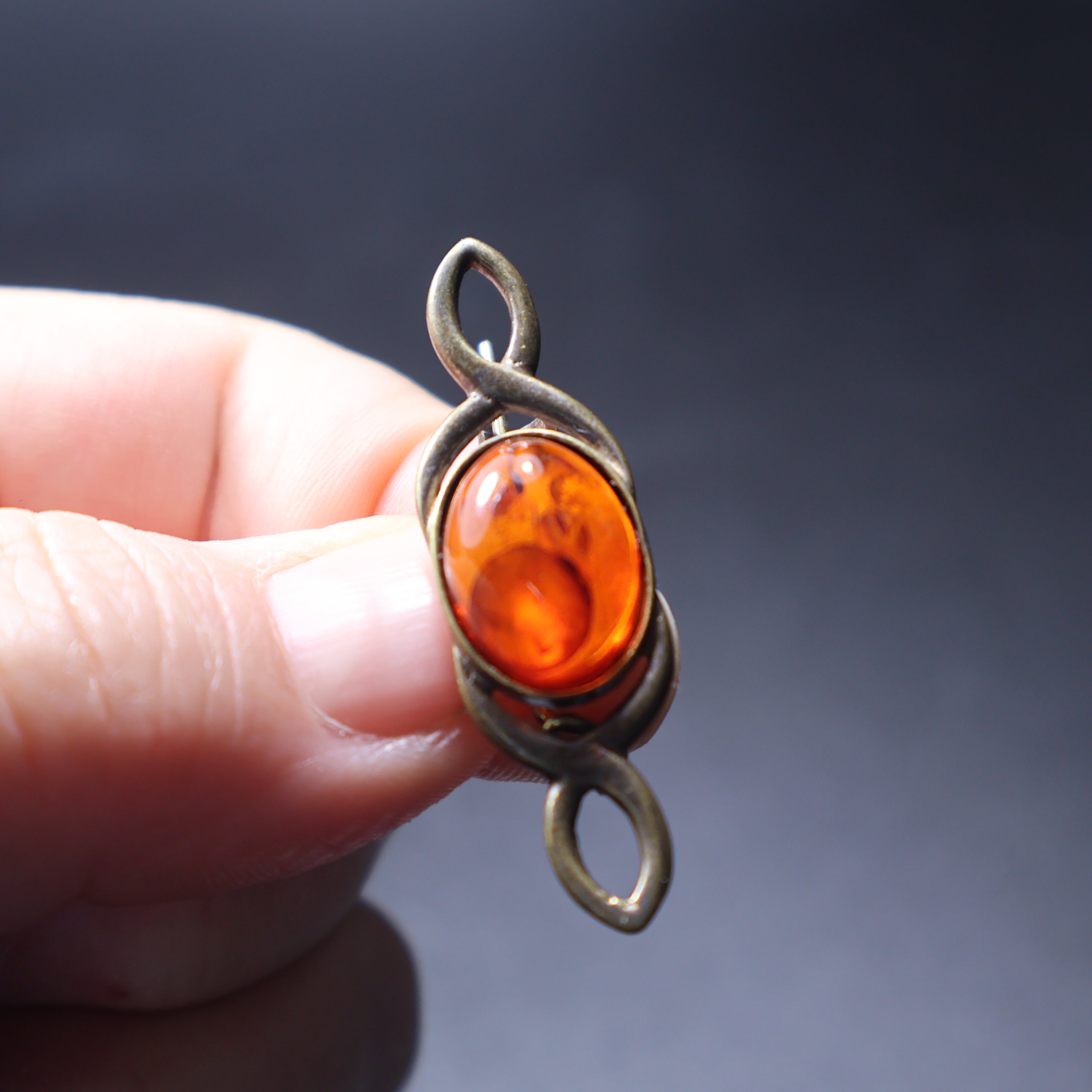 Handmade Baltic amber bar brooch close-up showing natural stone