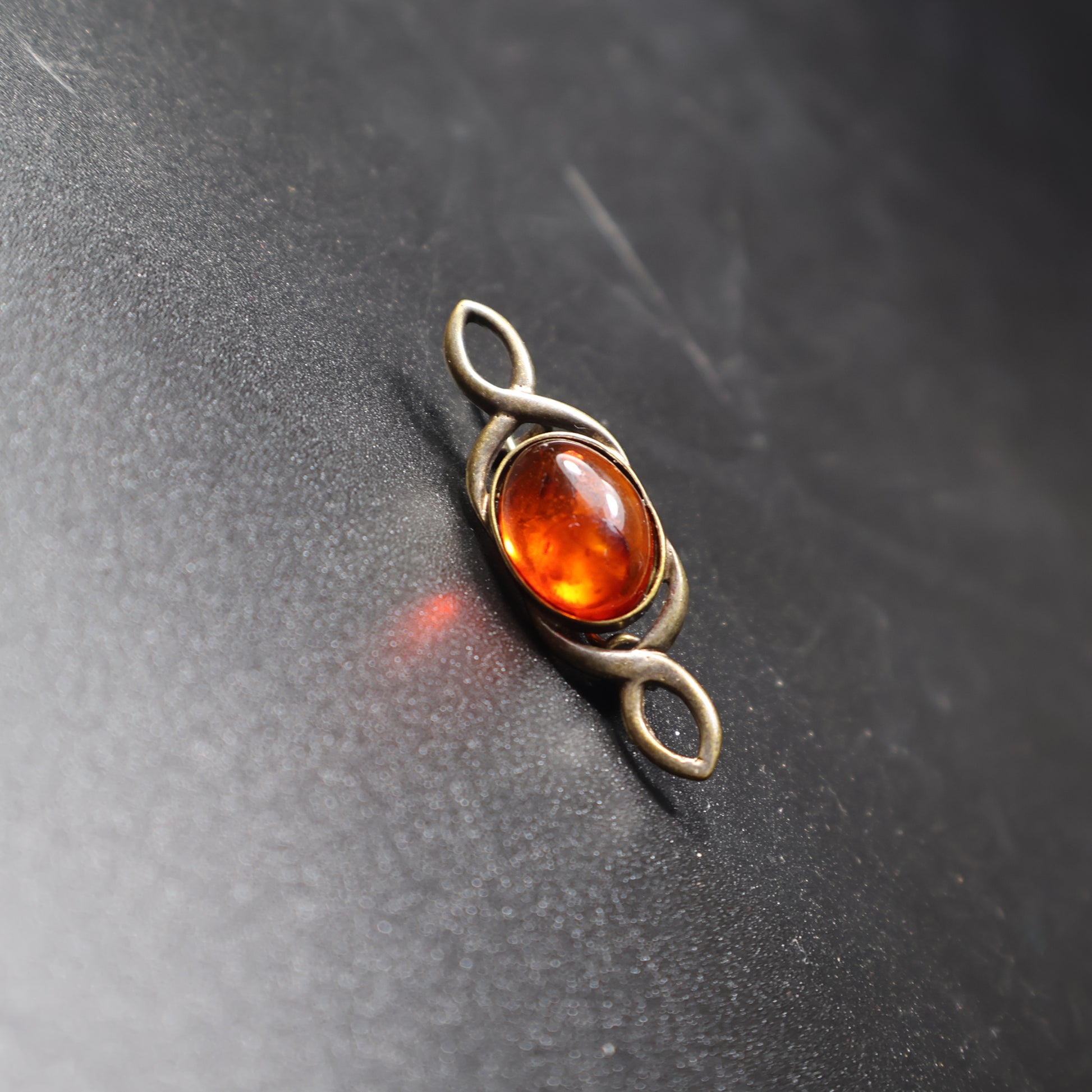 Genuine Baltic amber bar brooch infinity knot detail, handcrafted in Brooklyn NY