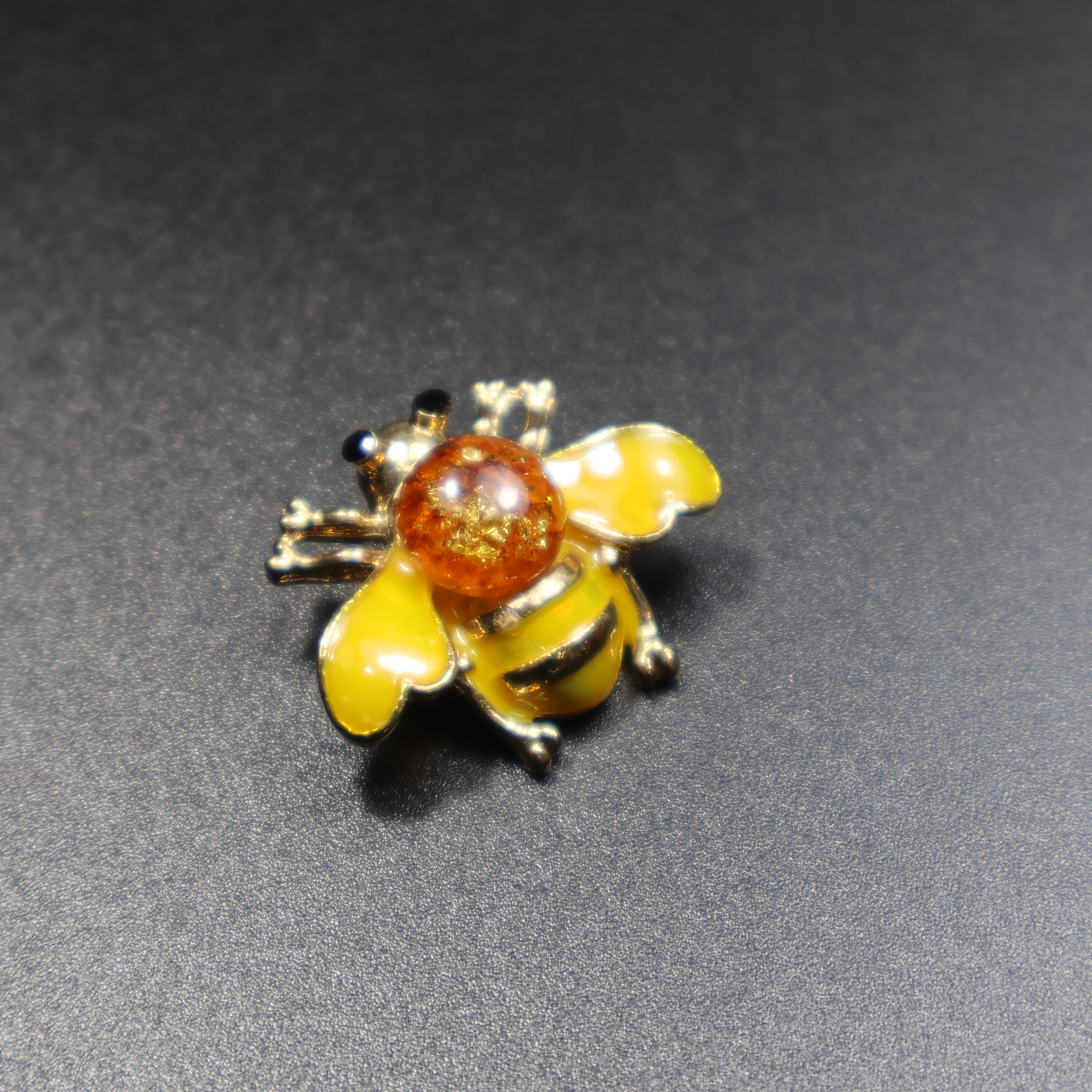 Baltic amber bee brooch blue variant close-up