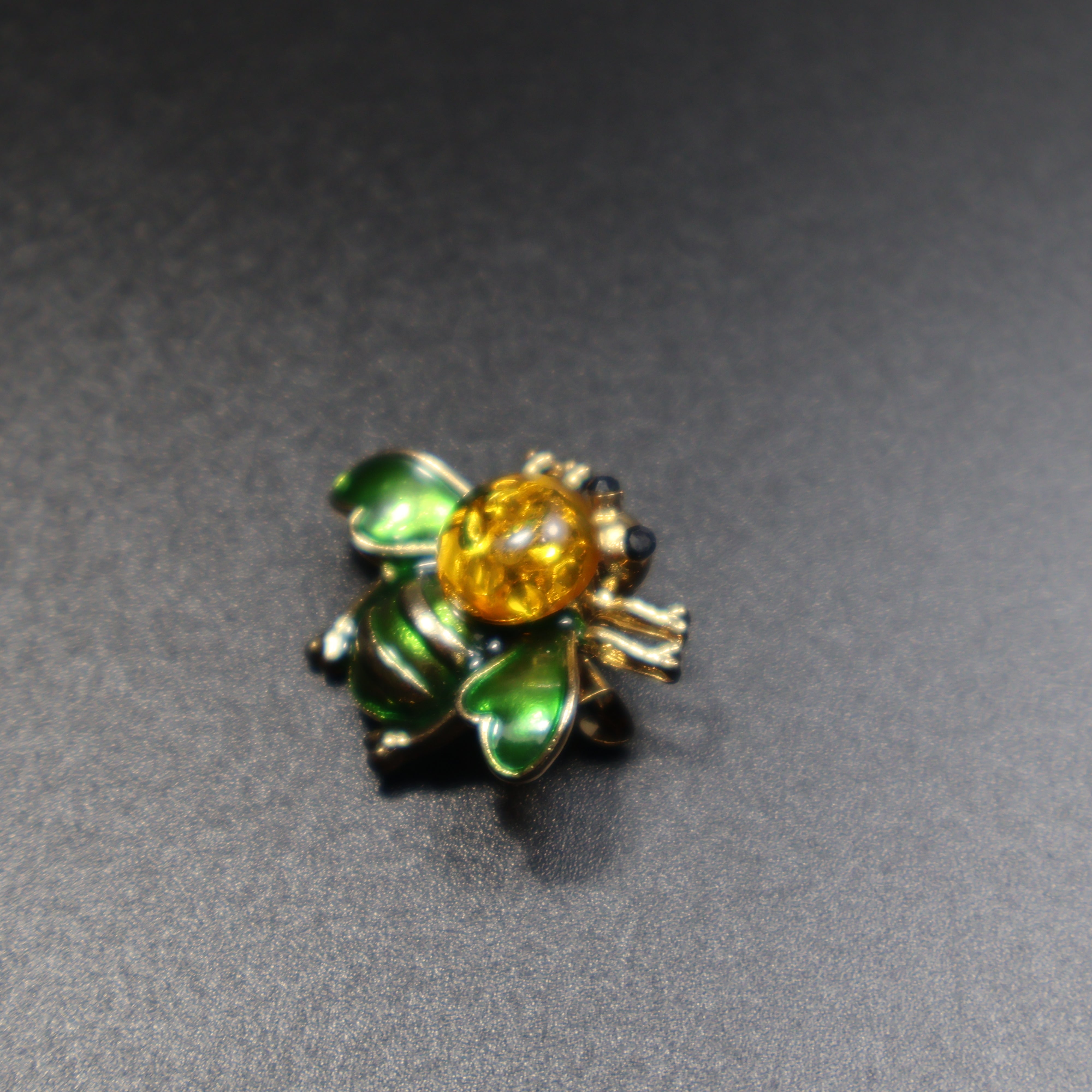 Baltic amber bee brooch color variants displayed together