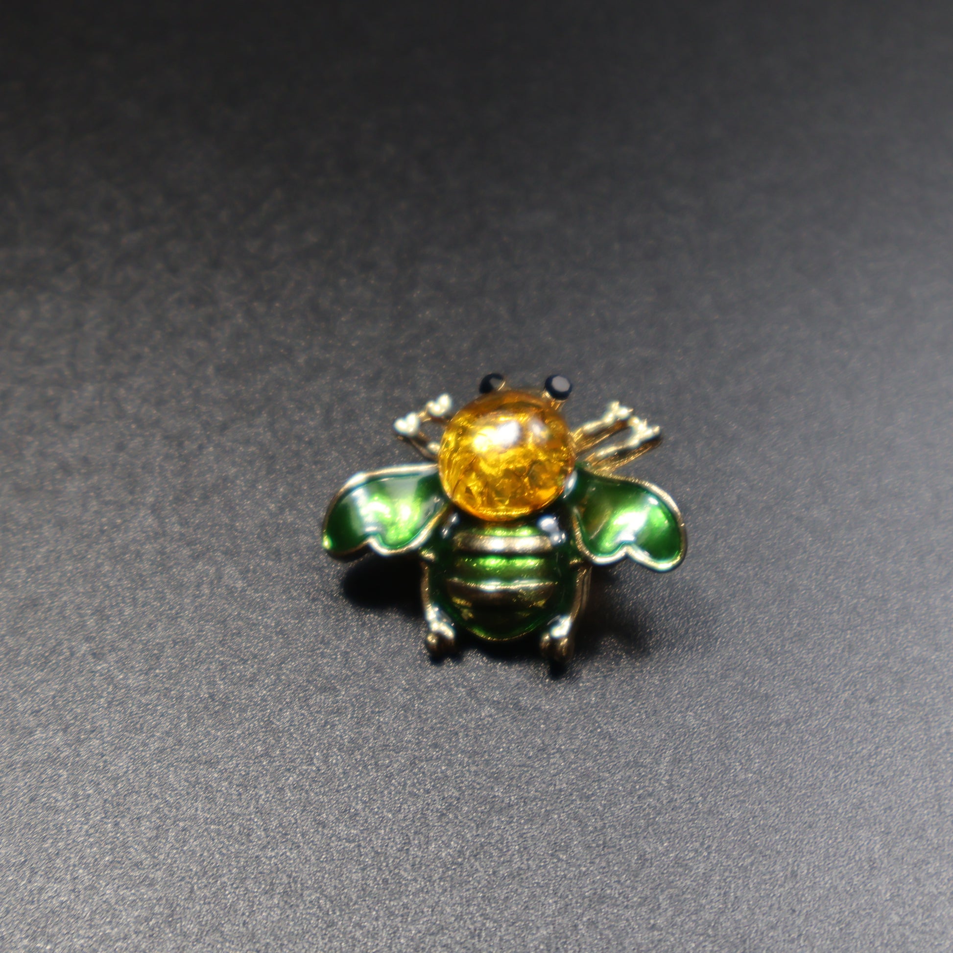 KIZIMA amber bee brooch worn as jewelry accessory