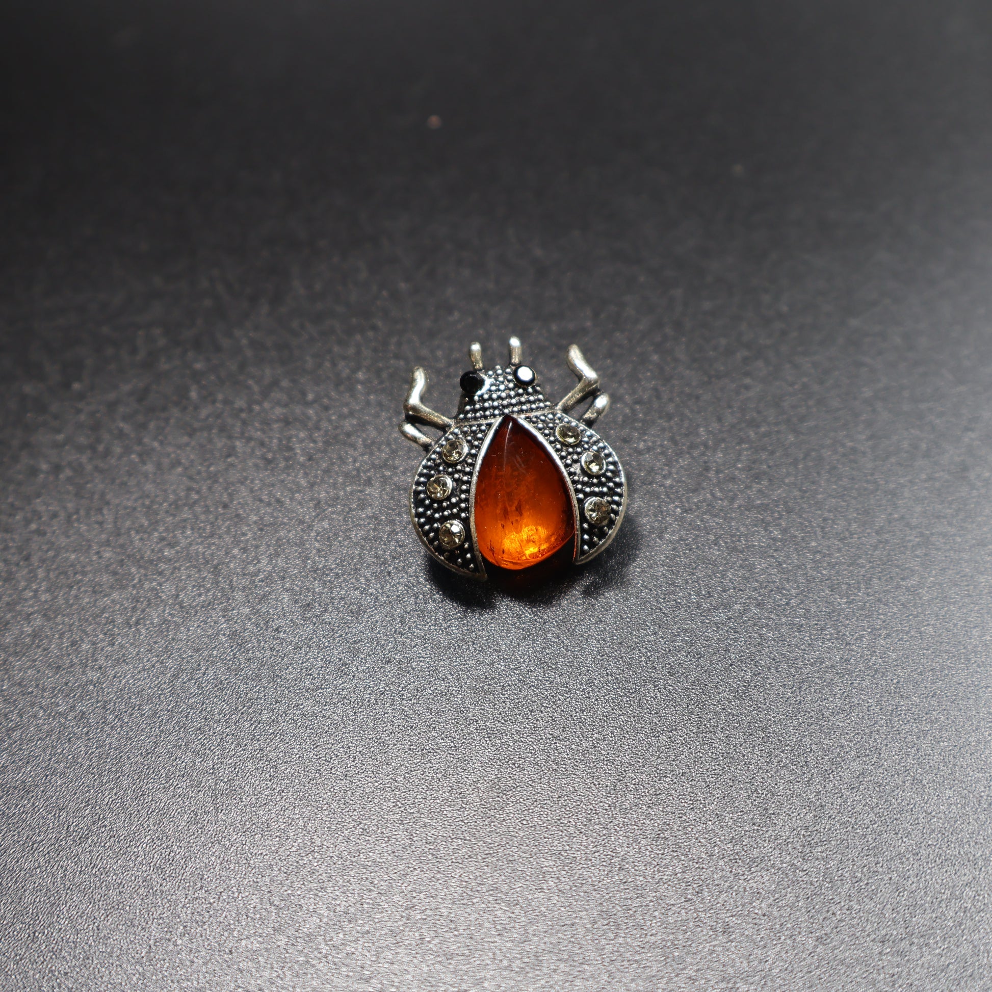 KIZIMA amber beetle brooch side view showing stone depth