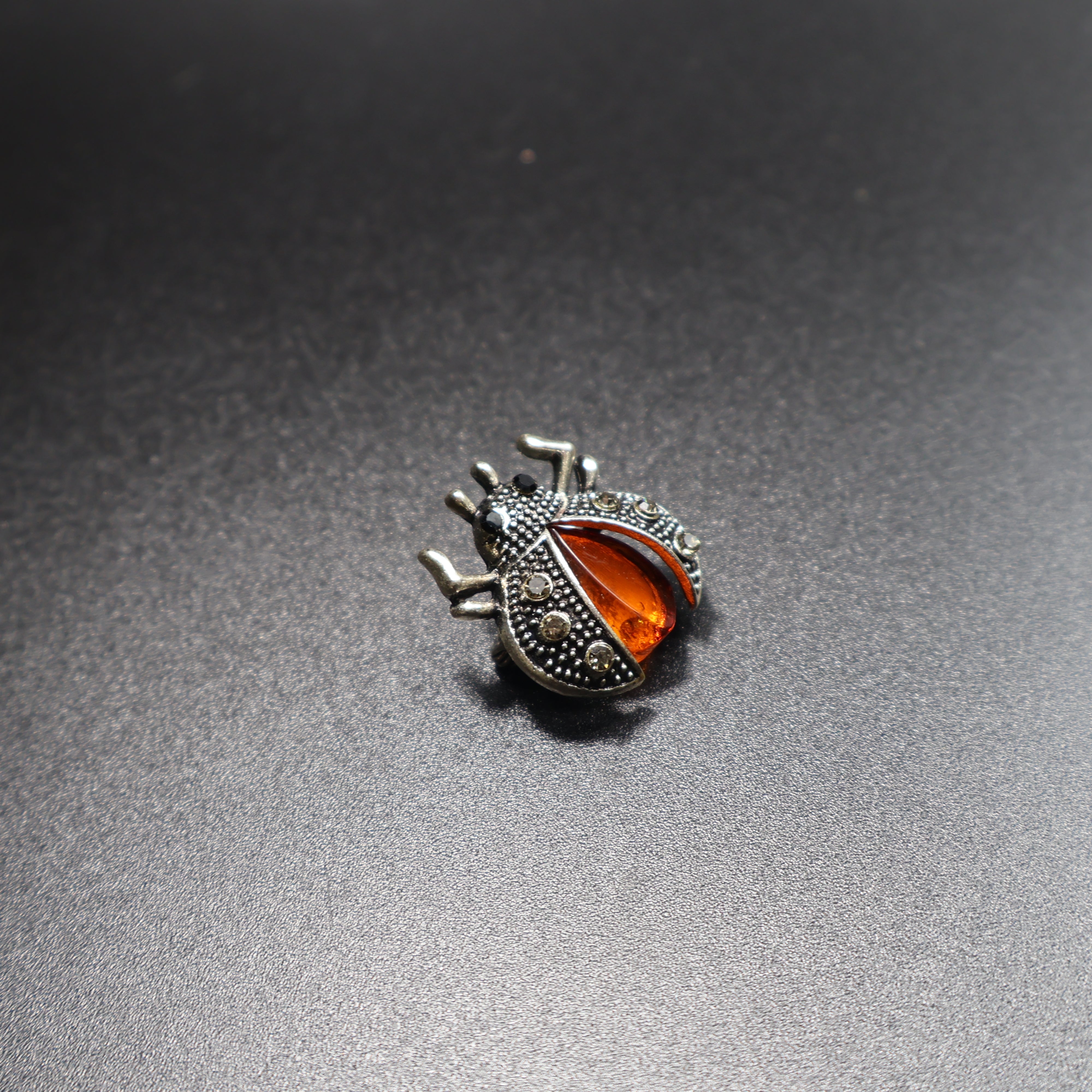 Genuine Baltic amber beetle brooch worn as jewelry accessory
