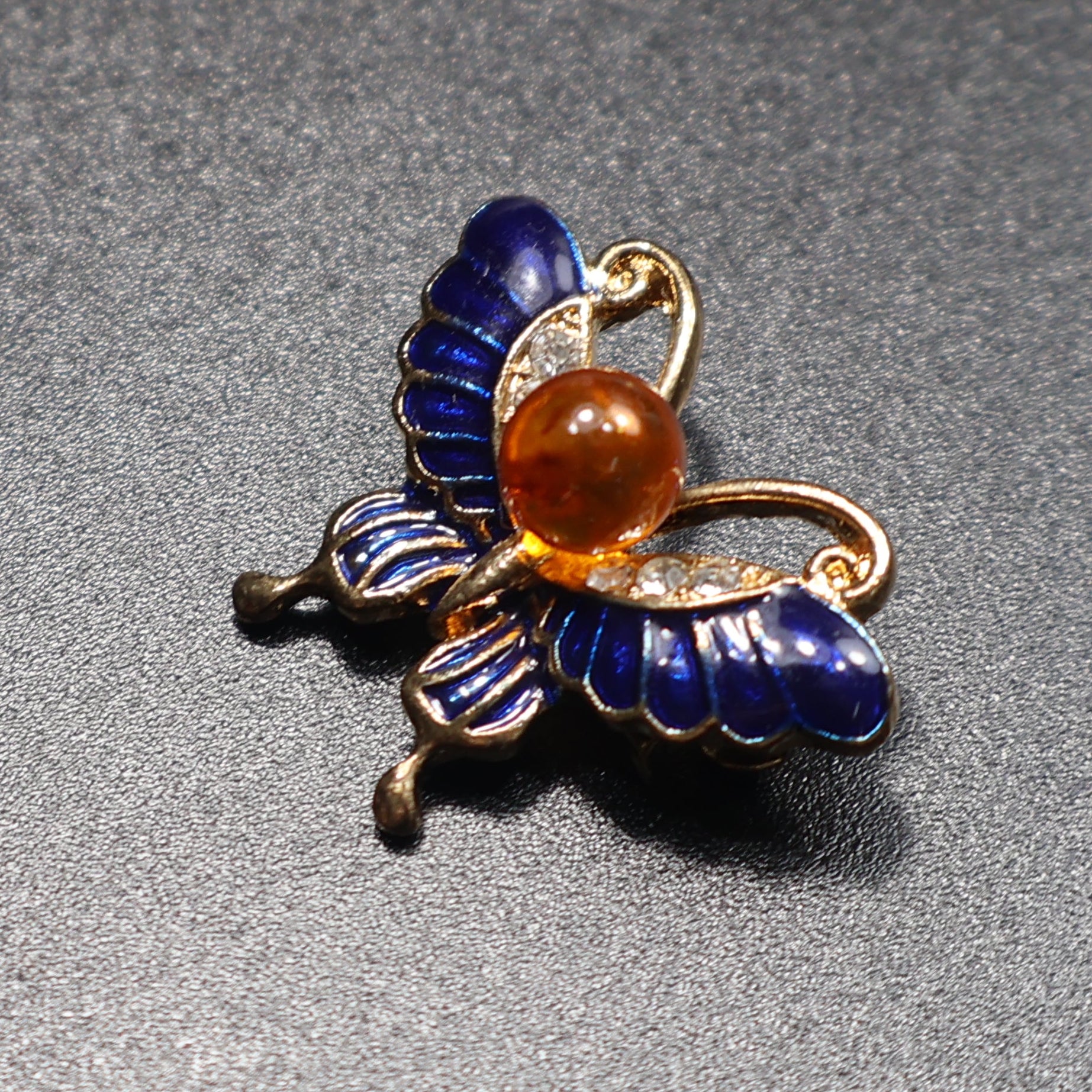 KIZIMA amber butterfly brooch worn as jewelry accessory