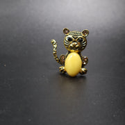 Handmade Baltic amber cat brooch gold close-up showing natural stone