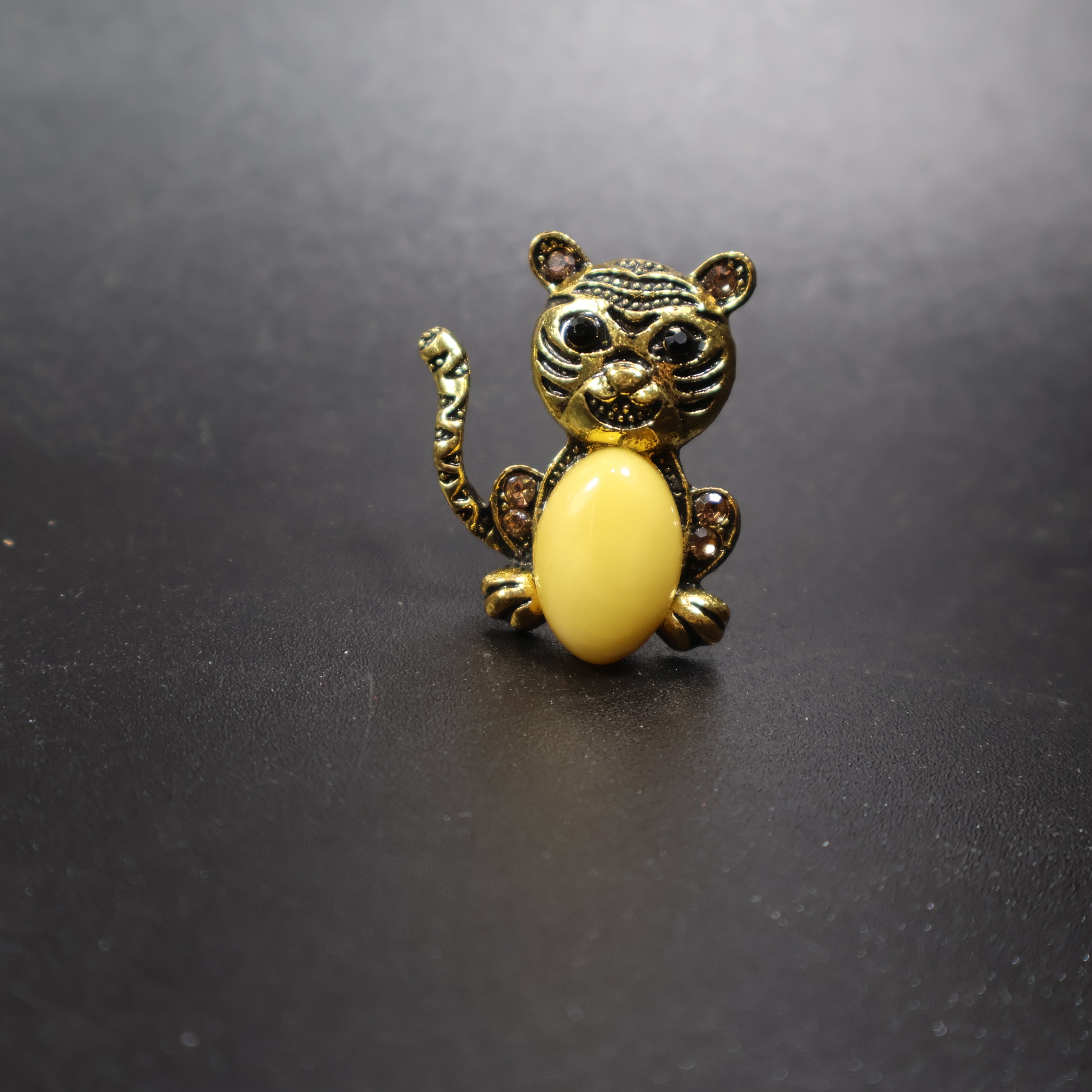 Natural Baltic amber cat brooch gold worn in hand
