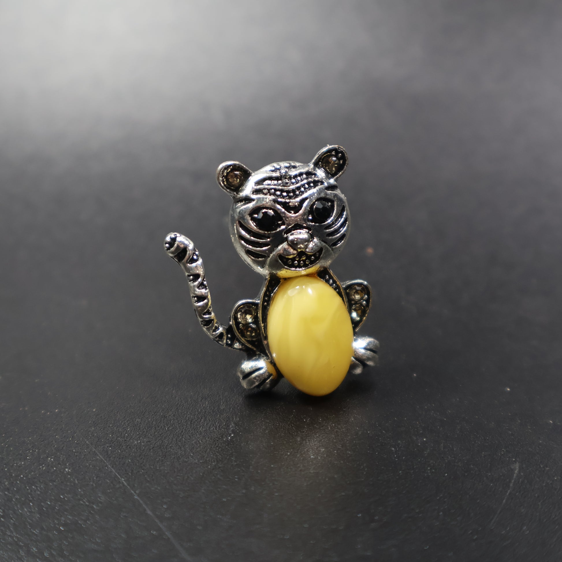 Handmade Baltic amber cat brooch silver amber close-up showing cognac stone