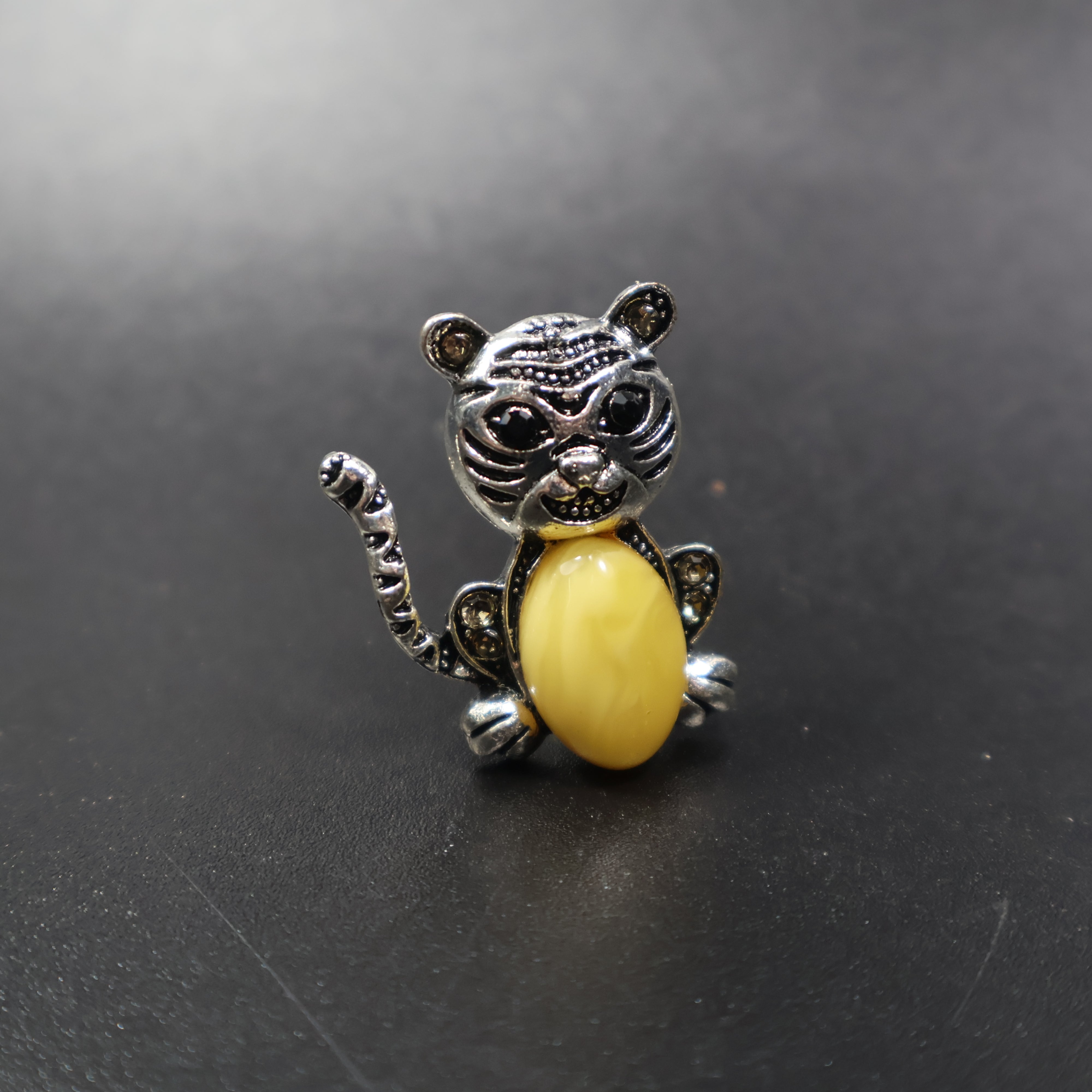 Handmade Baltic amber cat brooch silver amber close-up showing cognac stone