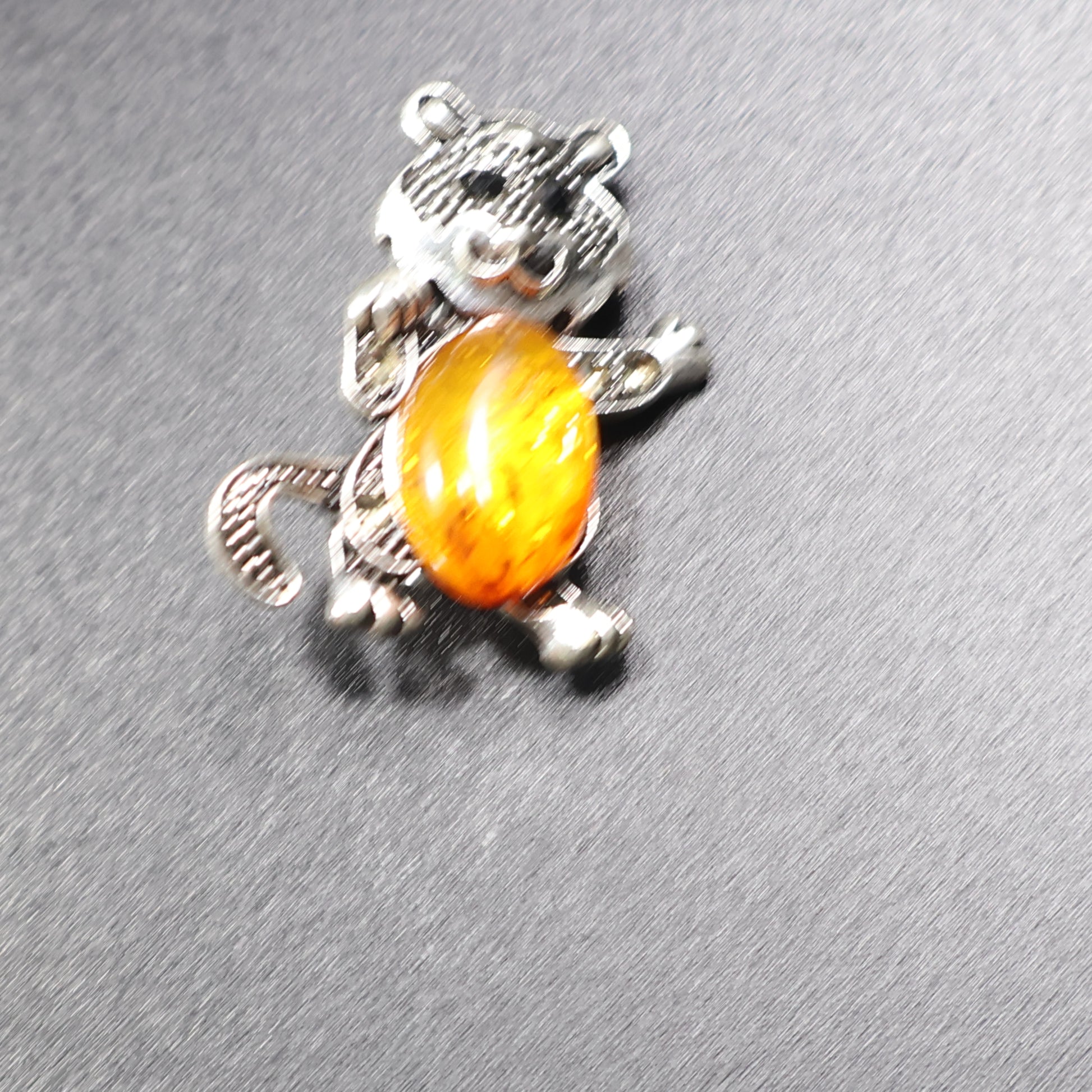 Handmade Baltic amber cat brooch silver tail down close-up