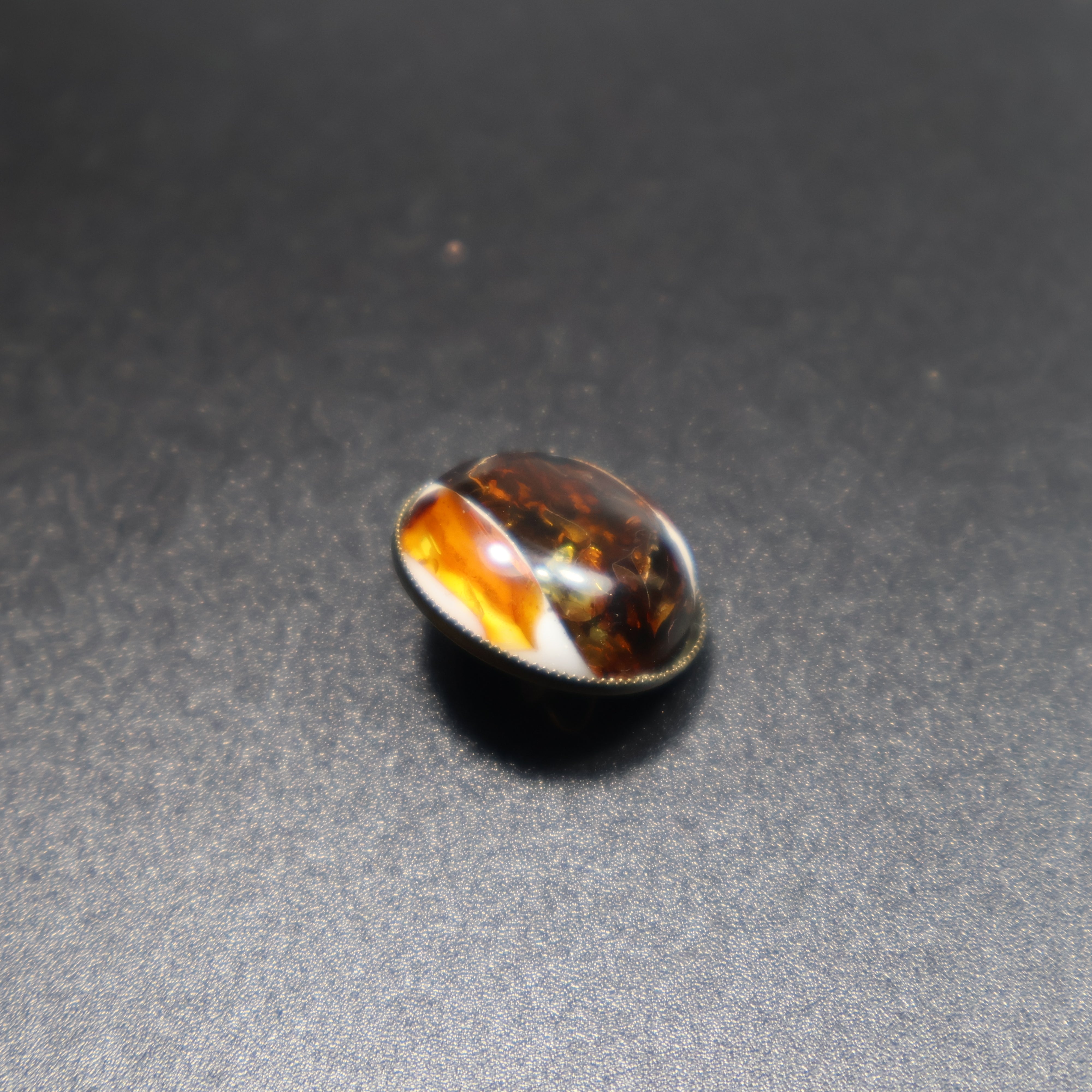 Handmade Baltic amber dalmatian brooch close-up showing natural stone