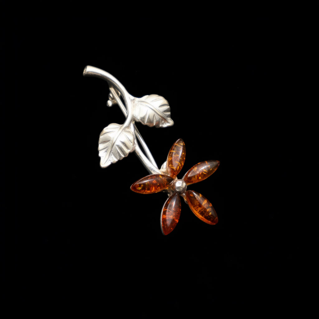 Handmade Baltic amber flower brooch close-up showing natural stone