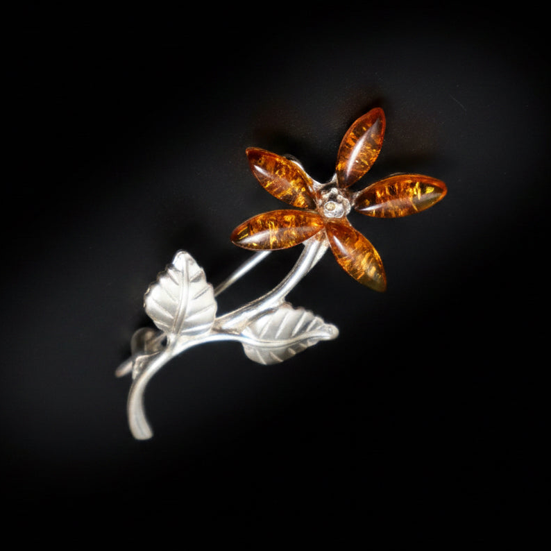 KIZIMA amber flower brooch worn as jewelry accessory