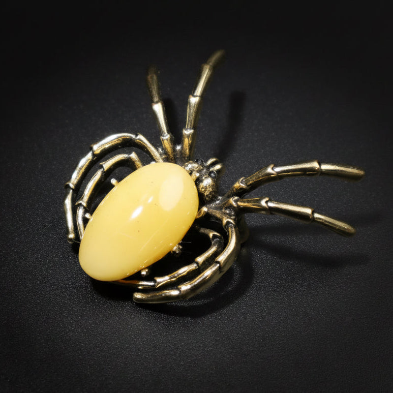 Handmade Baltic amber spider pin close-up showing natural stone