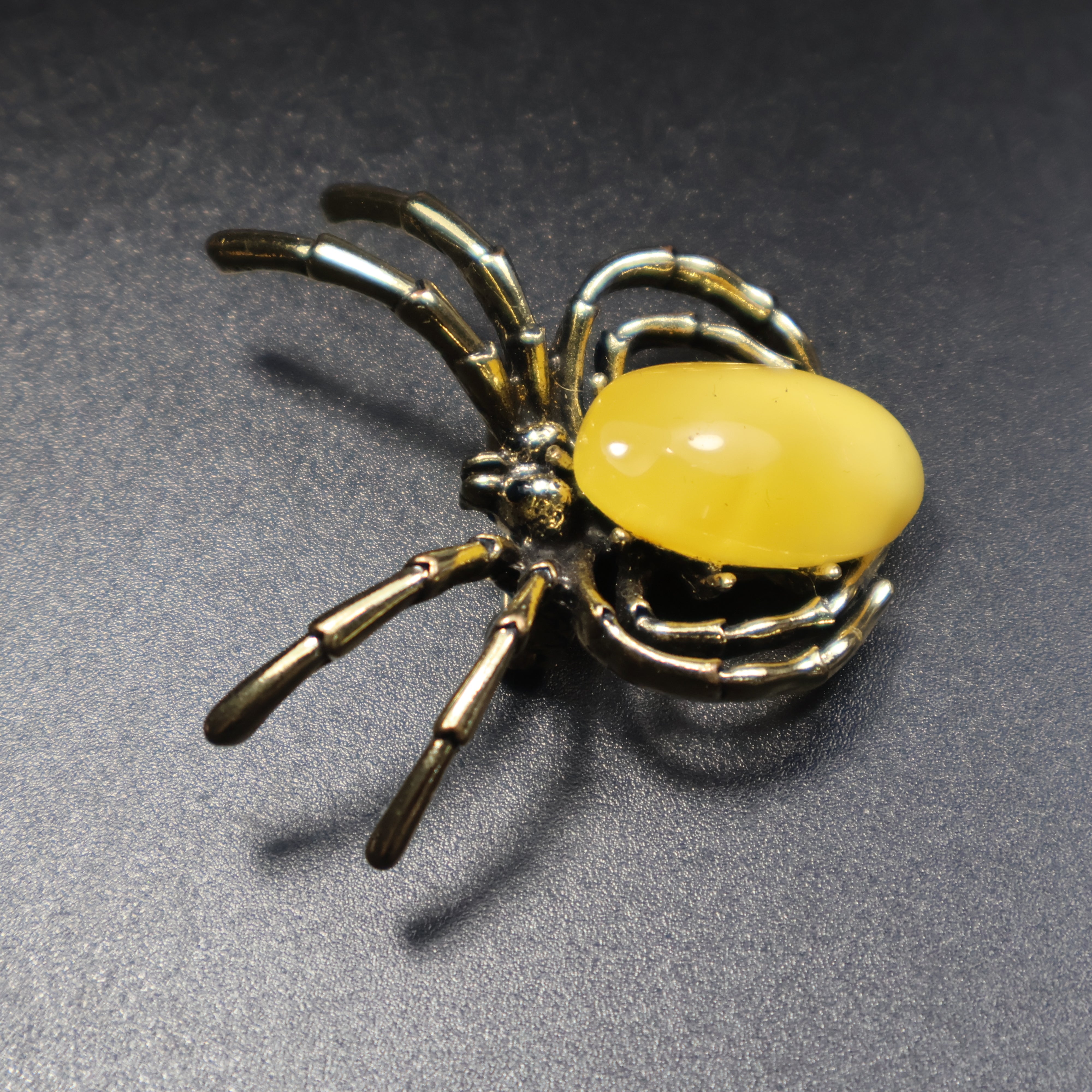 KIZIMA amber gothic spider pin worn as jewelry accessory