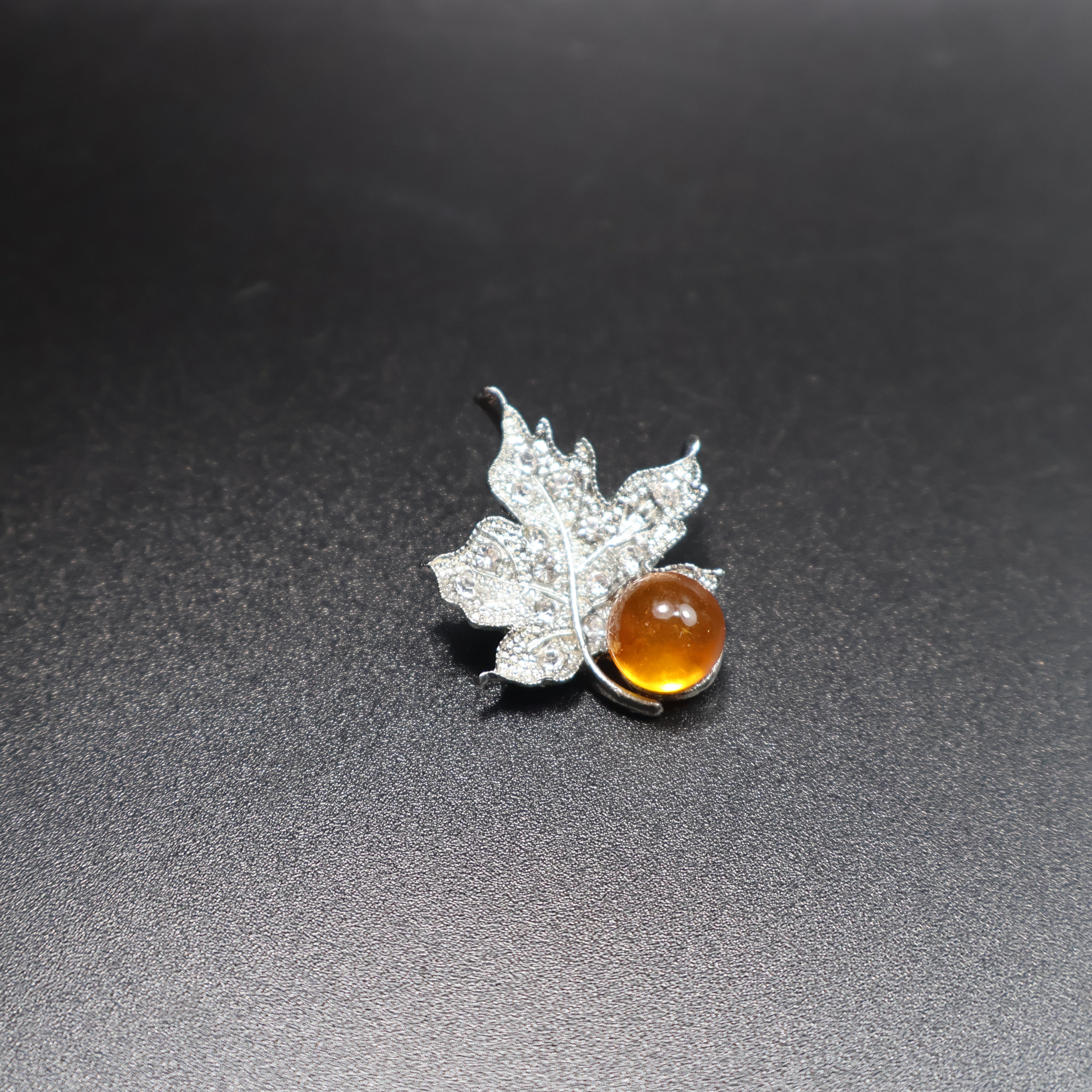 Handmade Baltic amber leaf brooch gold-tone setting close-up