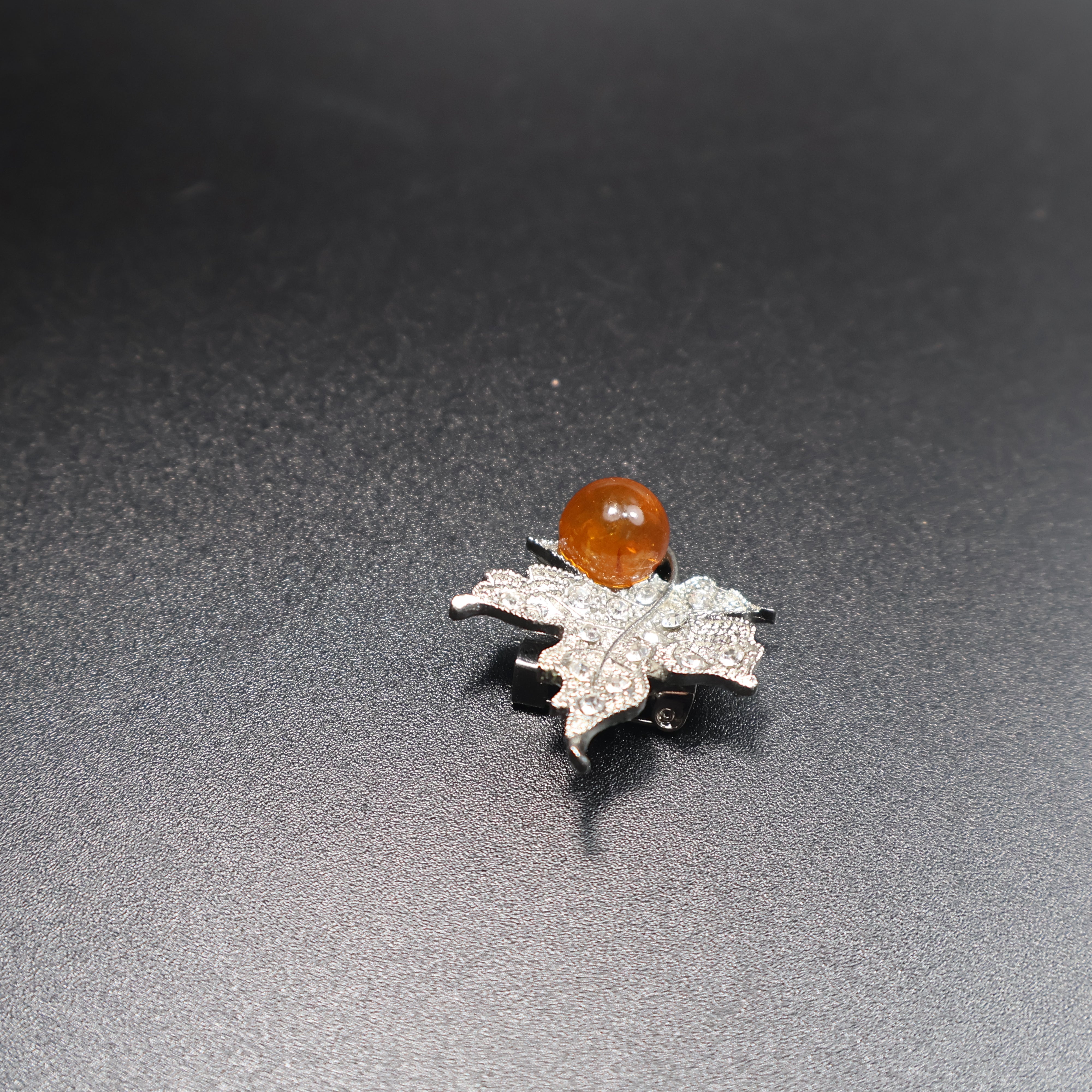Genuine Baltic amber leaf brooch worn as jewelry accessory
