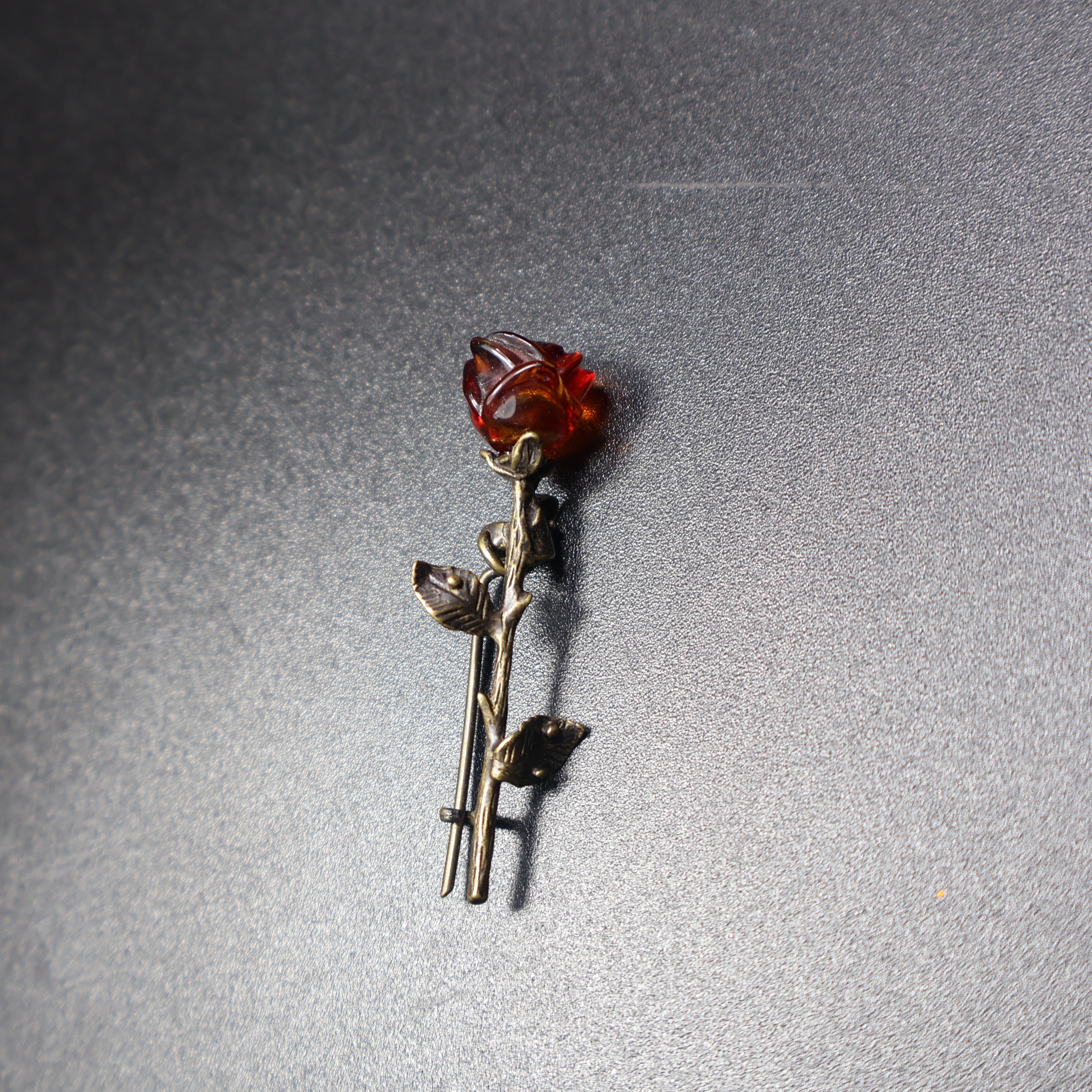 Handmade Baltic amber rose brooch close-up showing natural stone
