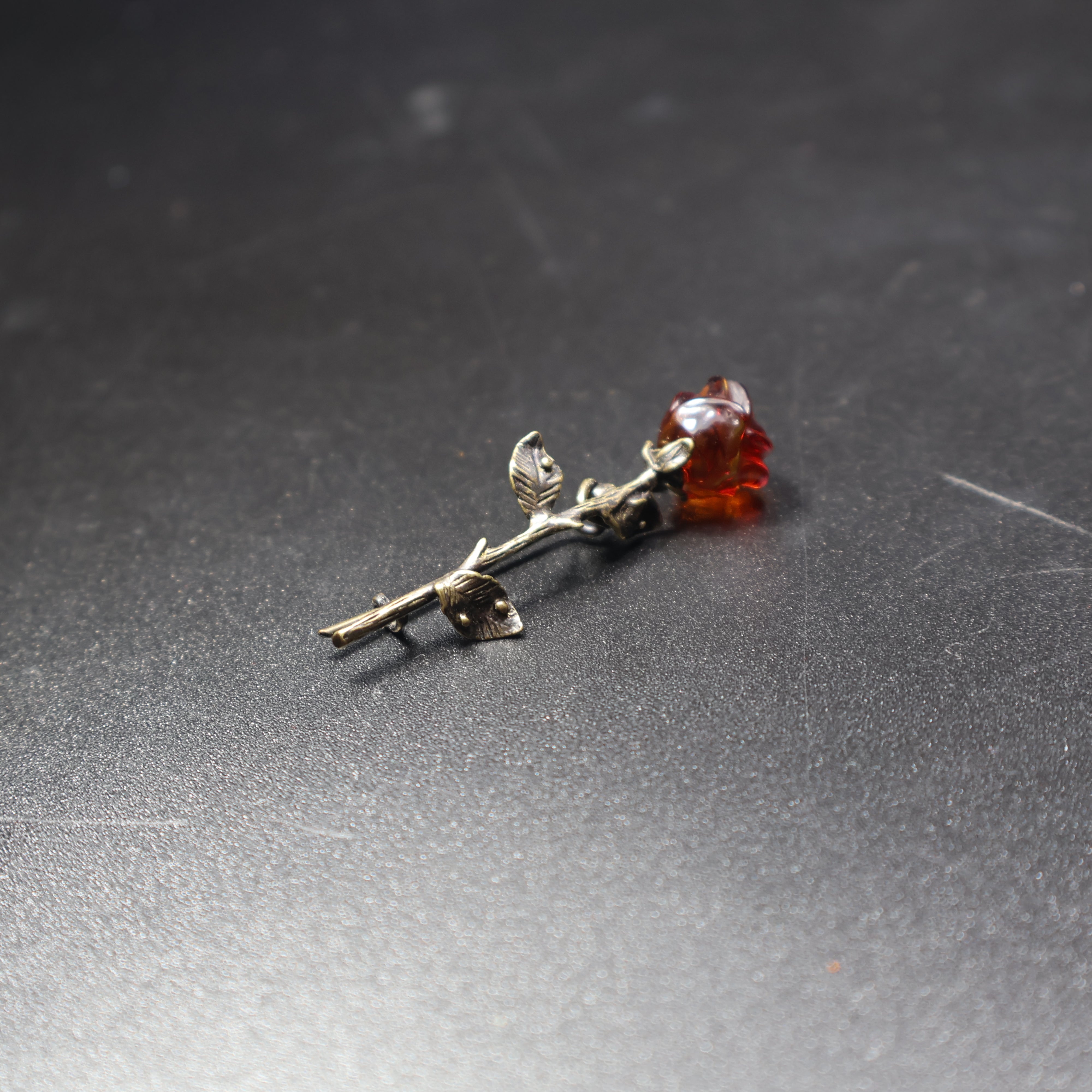 KIZIMA amber rose brooch worn as jewelry accessory